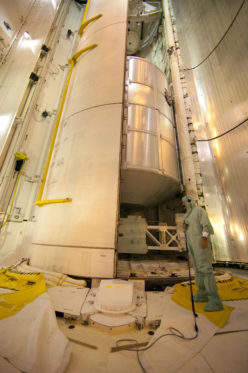 CAPE CANAVERAL, Fla. -- At Launch Pad 39A at NASA's Kennedy Space Center in Florida, technicians monitor the progress as space shuttle Atlantis' payload bay doors close around the Raffaello multi-purpose logistics module (MPLM) payload for Atlantis' STS-135 mission to the International Space Station.            Commander Chris Ferguson, Pilot Doug Hurley and Mission Specialists Sandra Magnus and Rex Walheim are slated to lift off on July 8, taking with them the MPLM packed with supplies and spare parts to the station. The STS-135 mission also will fly a system to investigate the potential for robotically refueling existing satellites and return a failed ammonia pump module to help NASA better understand the failure mechanism and improve pump designs for future systems. STS-135 will be the 33rd flight of Atlantis, the 37th shuttle mission to the space station, and the 135th and final mission of NASA's Space Shuttle Program. For more information visit, www.nasa.gov/mission_pages/shuttle/shuttlemissions/sts135/index.html. Photo credit: NASA/Frank Michaux