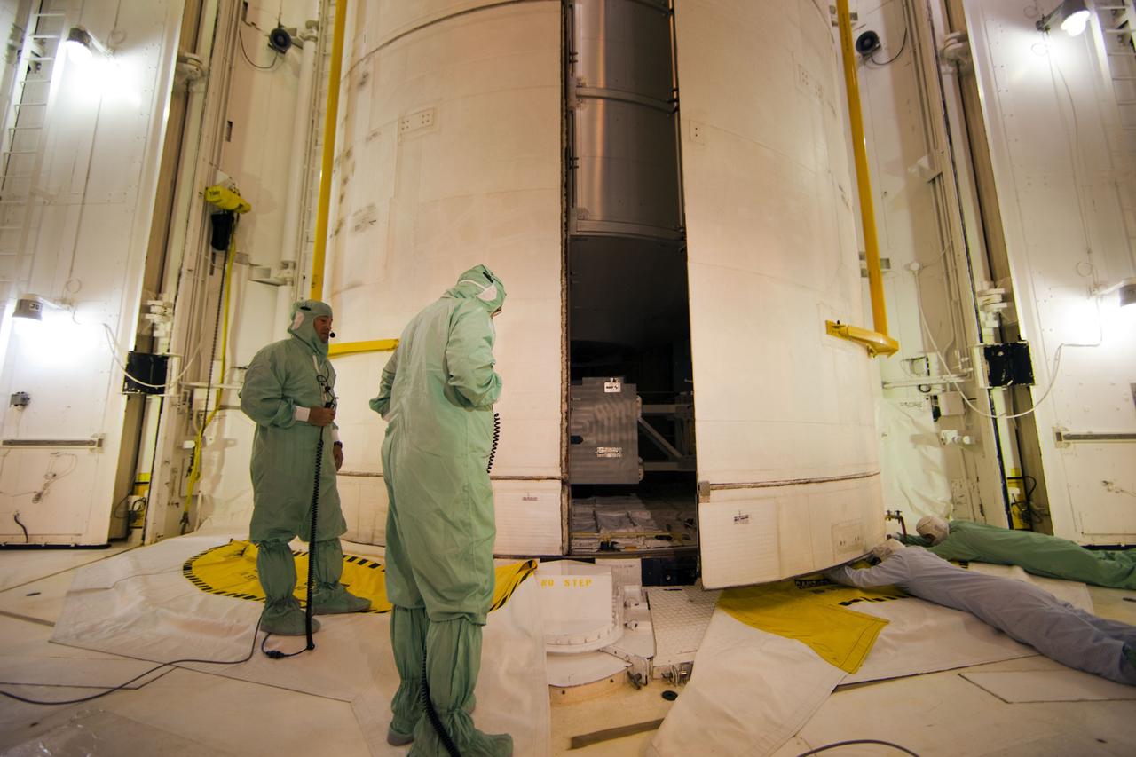 CAPE CANAVERAL, Fla. -- At Launch Pad 39A at NASA's Kennedy Space Center in Florida, technicians guide the progress of space shuttle Atlantis' payload bay doors as they close around the Raffaello multi-purpose logistics module (MPLM) payload for Atlantis' STS-135 mission to the International Space Station.          Commander Chris Ferguson, Pilot Doug Hurley and Mission Specialists Sandra Magnus and Rex Walheim are slated to lift off on July 8, taking with them the MPLM packed with supplies and spare parts to the station. The STS-135 mission also will fly a system to investigate the potential for robotically refueling existing satellites and return a failed ammonia pump module to help NASA better understand the failure mechanism and improve pump designs for future systems. STS-135 will be the 33rd flight of Atlantis, the 37th shuttle mission to the space station, and the 135th and final mission of NASA's Space Shuttle Program. For more information visit, www.nasa.gov/mission_pages/shuttle/shuttlemissions/sts135/index.html. Photo credit: NASA/Frank Michaux