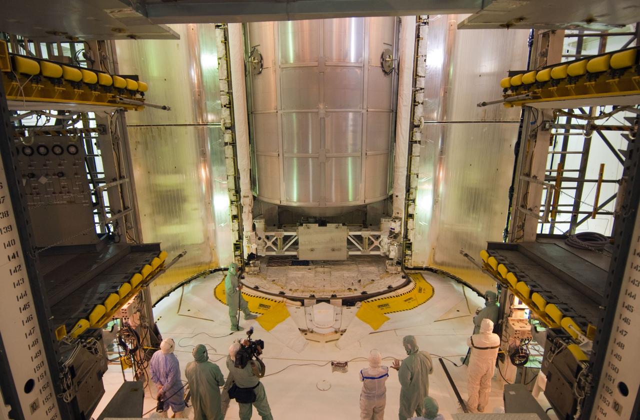 CAPE CANAVERAL, Fla. -- In the payload changeout room at Launch Pad 39A at NASA's Kennedy Space Center in Florida, technicians prepare for the closure of space shuttle Atlantis' payload bay doors for flight. The payload arrived at the pad June 16 for installation into Atlantis and includes the Raffaello multi-purpose logistics module packed with supplies and spare parts for the International Space Station. The STS-135 mission also will fly a system to investigate the potential for robotically refueling existing satellites and return a failed ammonia pump module to help NASA better understand the failure mechanism and improve pump designs for future systems. Atlantis and its crew are scheduled to lift off at 11:26 a.m. EDT July 8. STS-135 will be the 33rd flight of Atlantis, the 37th shuttle mission to the space station, and the 135th and final mission of NASA's Space Shuttle Program. For more information, visit www.nasa.gov/shuttle. Photo credit: NASA/Jim Grossmann