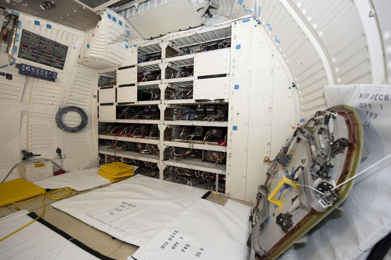 CAPE CANAVERAL, Fla. -- In Orbiter Processing Facility-1 at NASA's Kennedy Space Center in Florida, workers are disconnecting and dismantling components on shuttle Endeavour's mid-deck. The work is part of Endeavour's transition and retirement processing. The spacecraft is being prepared for public display at the California Science Center in Los Angeles. Endeavour flew 25 missions, spent 299 days in space, orbited Earth 4,671 times and traveled 122,883,151 miles over the course of its 19-year career. Endeavour's STS-134 and final mission was completed after landing on June 1, 2011. Photo credit: NASA/Kim Shiflett