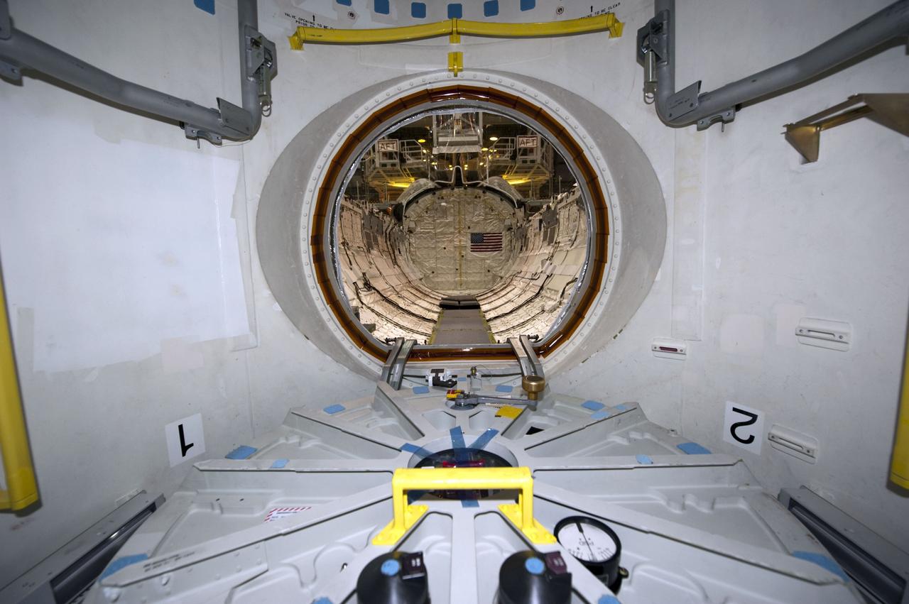 CAPE CANAVERAL, Fla. -- In Orbiter Processing Facility-1 at NASA's Kennedy Space Center in Florida, workers are disconnecting and dismantling components on shuttle Endeavour. Seen here is the view from inside the spacecraft's airlock looking toward the payload bay. The work is part of Endeavour's transition and retirement processing. The spacecraft is being prepared for public display at the California Science Center in Los Angeles. Endeavour flew 25 missions, spent 299 days in space, orbited Earth 4,671 times and traveled 122,883,151 miles over the course of its 19-year career. Endeavour's STS-134 and final mission was completed after landing on June 1, 2011. Photo credit: NASA/Kim Shiflett