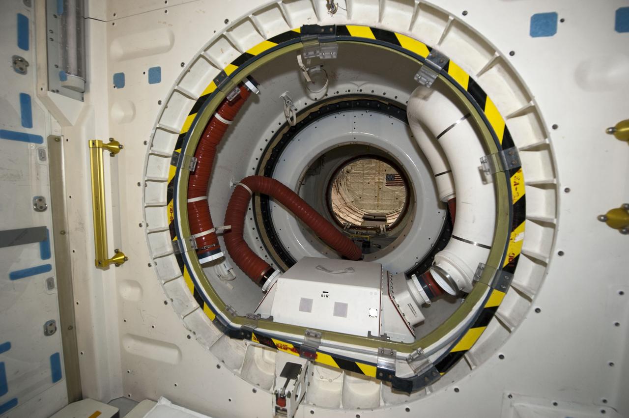 CAPE CANAVERAL, Fla. -- In Orbiter Processing Facility-1 at NASA's Kennedy Space Center in Florida, workers are disconnecting and dismantling components on shuttle Endeavour. Seen here is the view from inside the spacecraft's airlock looking toward the payload bay. The work is part of Endeavour's transition and retirement processing. The spacecraft is being prepared for public display at the California Science Center in Los Angeles. Endeavour flew 25 missions, spent 299 days in space, orbited Earth 4,671 times and traveled 122,883,151 miles over the course of its 19-year career. Endeavour's STS-134 and final mission was completed after landing on June 1, 2011. Photo credit: NASA/Kim Shiflett