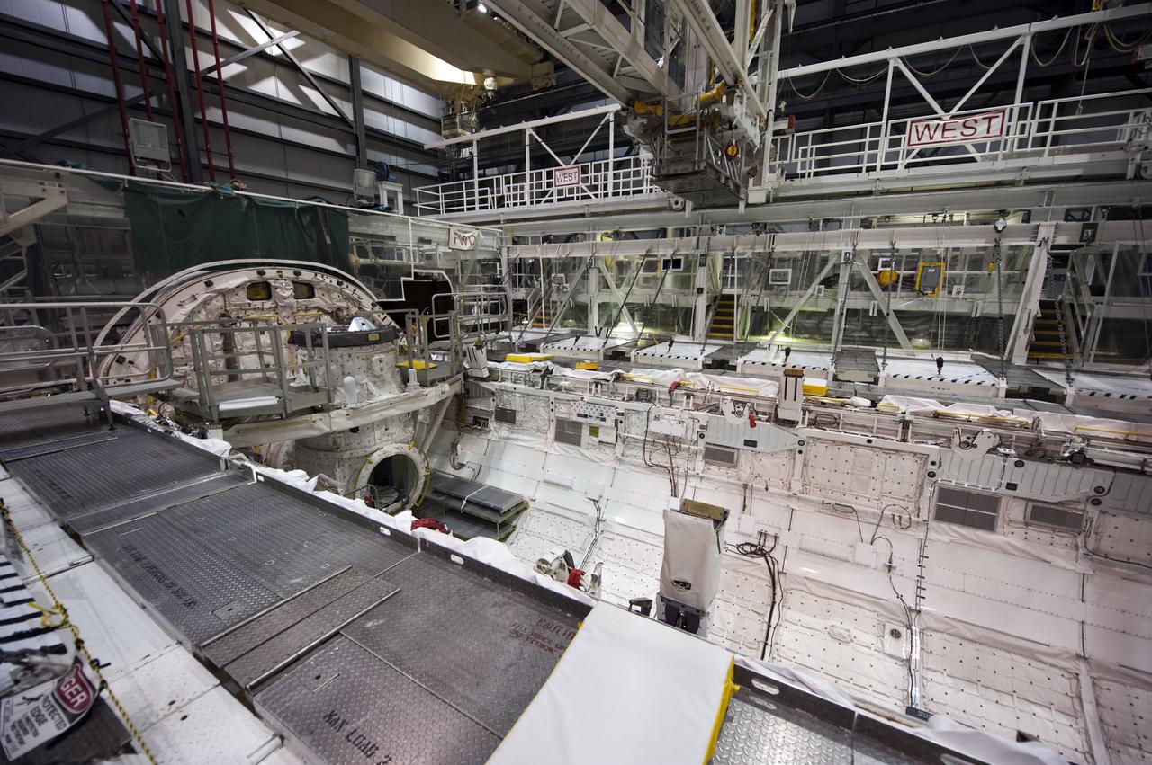 CAPE CANAVERAL, Fla. -- In Orbiter Processing Facility-1 at NASA's Kennedy Space Center in Florida, workers are disconnecting and dismantling components on shuttle Endeavour. Seen here is the spacecraft's payload bay. The work is part of Endeavour's transition and retirement processing. The spacecraft is being prepared for public display at the California Science Center in Los Angeles. Endeavour flew 25 missions, spent 299 days in space, orbited Earth 4,671 times and traveled 122,883,151 miles over the course of its 19-year career. Endeavour's STS-134 and final mission was completed after landing on June 1, 2011. Photo credit: NASA/Kim Shiflett