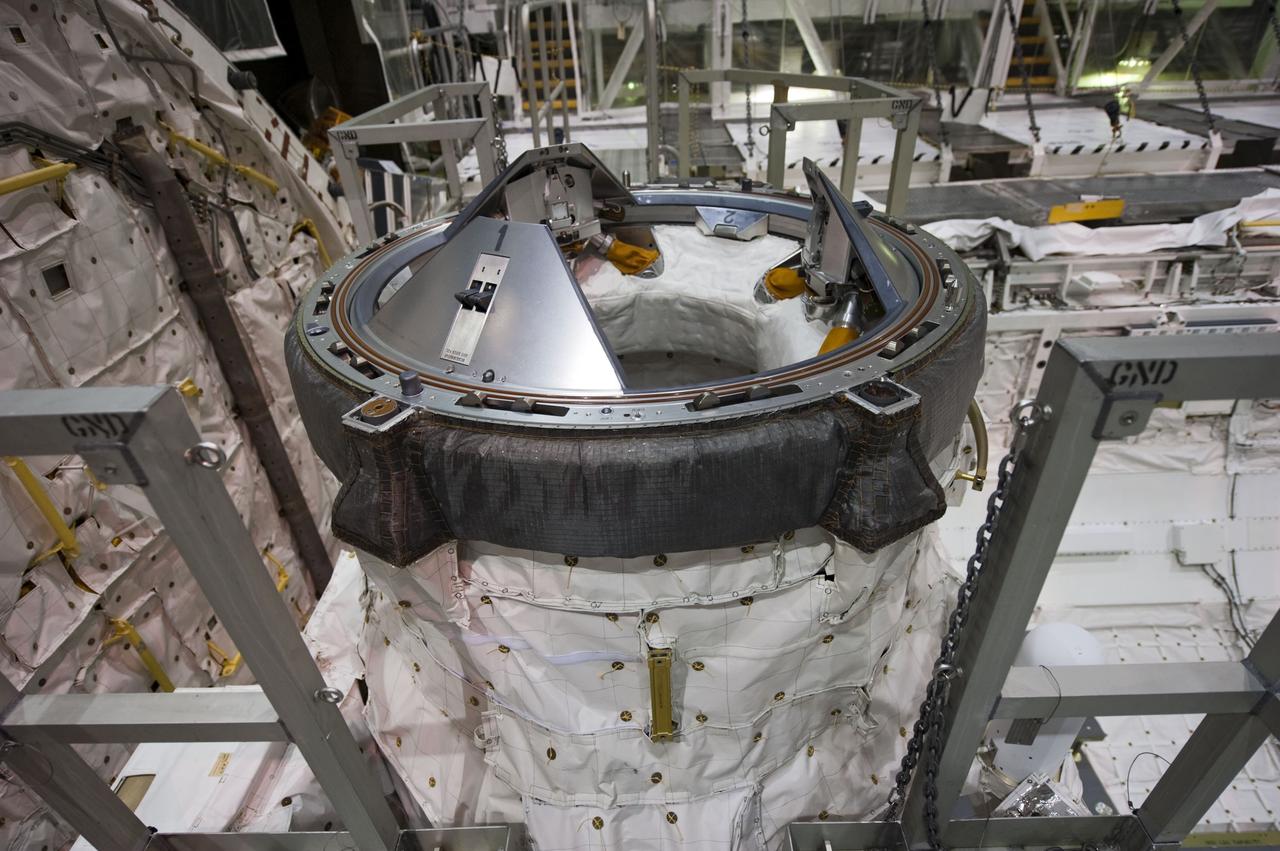 CAPE CANAVERAL, Fla. -- In Orbiter Processing Facility-1 at NASA's Kennedy Space Center in Florida, workers are disconnecting and dismantling components on shuttle Endeavour. Seen here is the spacecraft's docking port in the payload bay. The work is part of Endeavour's transition and retirement processing. The spacecraft is being prepared for public display at the California Science Center in Los Angeles. Endeavour flew 25 missions, spent 299 days in space, orbited Earth 4,671 times and traveled 122,883,151 miles over the course of its 19-year career. Endeavour's STS-134 and final mission was completed after landing on June 1, 2011. Photo credit: NASA/Kim Shiflett
