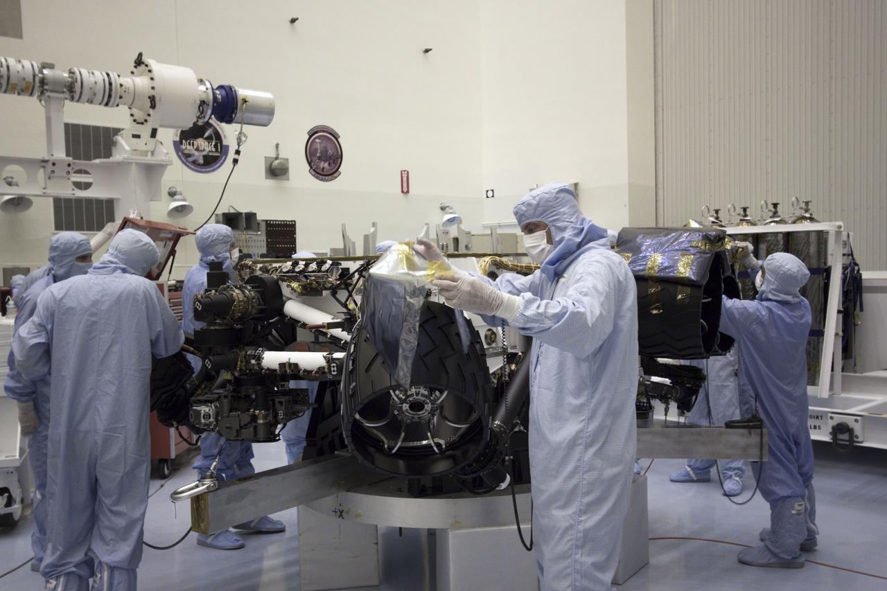 Cape Canaveral, Fla. -- At the Payload Hazardous Servicing Facility at NASA's Kennedy Space Center in Florida, technicians remove the protective cover from NASA's Mars Science Laboratory (MSL) rover known as Curiosity, before processing and testing.      A United Launch Alliance Atlas V-541 configuration will be used to loft MSL into space. Curiosity’s 10 science instruments are designed to search for evidence on whether Mars has had environments favorable to microbial life, including chemical ingredients for life.  The unique rover will use a laser to look inside rocks and release its gasses so that the rover’s spectrometer can analyze and send the data back to Earth. MSL is scheduled to launch from Cape Canaveral Air Force Station in Florida Nov. 25 with a window extending to Dec. 18 and arrival at Mars Aug. 2012. For more information, visit http://www.nasa.gov/msl. Photo credit: NASA/Jim Grossmann