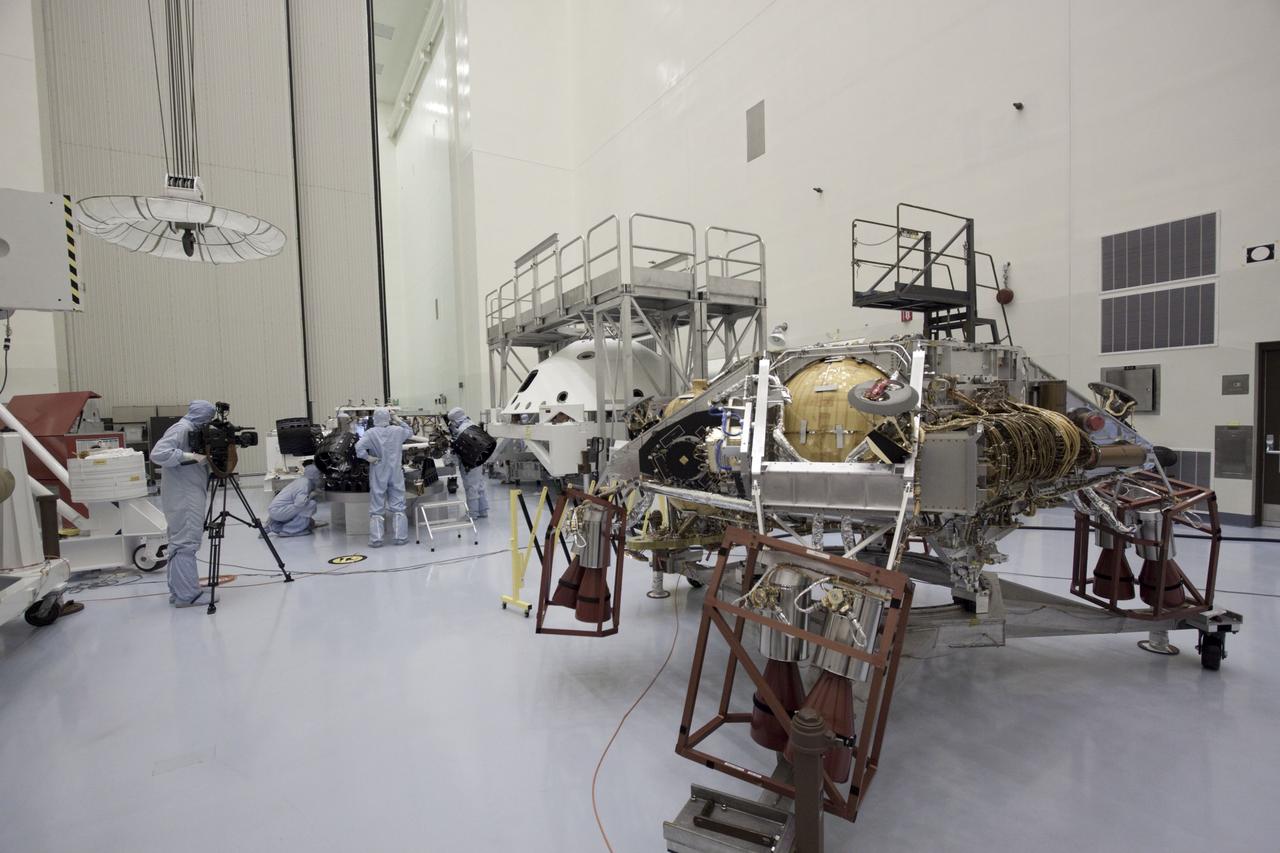 Cape Canaveral, Fla. -- At the Payload Hazardous Servicing Facility at NASA's Kennedy Space Center in Florida, NASA's Mars Science Laboratory (MSL) rover known as Curiosity, is secured on a work stand for processing (background left). The spacecraft's backshell (right), which carries the parachute and several components used during later stages of entry, descent and landing, in addition is the rocket-powered descent stage (foreground right), also visible in the image.      A United Launch Alliance Atlas V-541 configuration will be used to loft MSL into space. Curiosity’s 10 science instruments are designed to search for evidence on whether Mars has had environments favorable to microbial life, including chemical ingredients for life.  The unique rover will use a laser to look inside rocks and release its gasses so that the rover’s spectrometer can analyze and send the data back to Earth. MSL is scheduled to launch from Cape Canaveral Air Force Station in Florida Nov. 25 with a window extending to Dec. 18 and arrival at Mars Aug. 2012. For more information, visit http://www.nasa.gov/msl. Photo credit: NASA/Jim Grossmann
