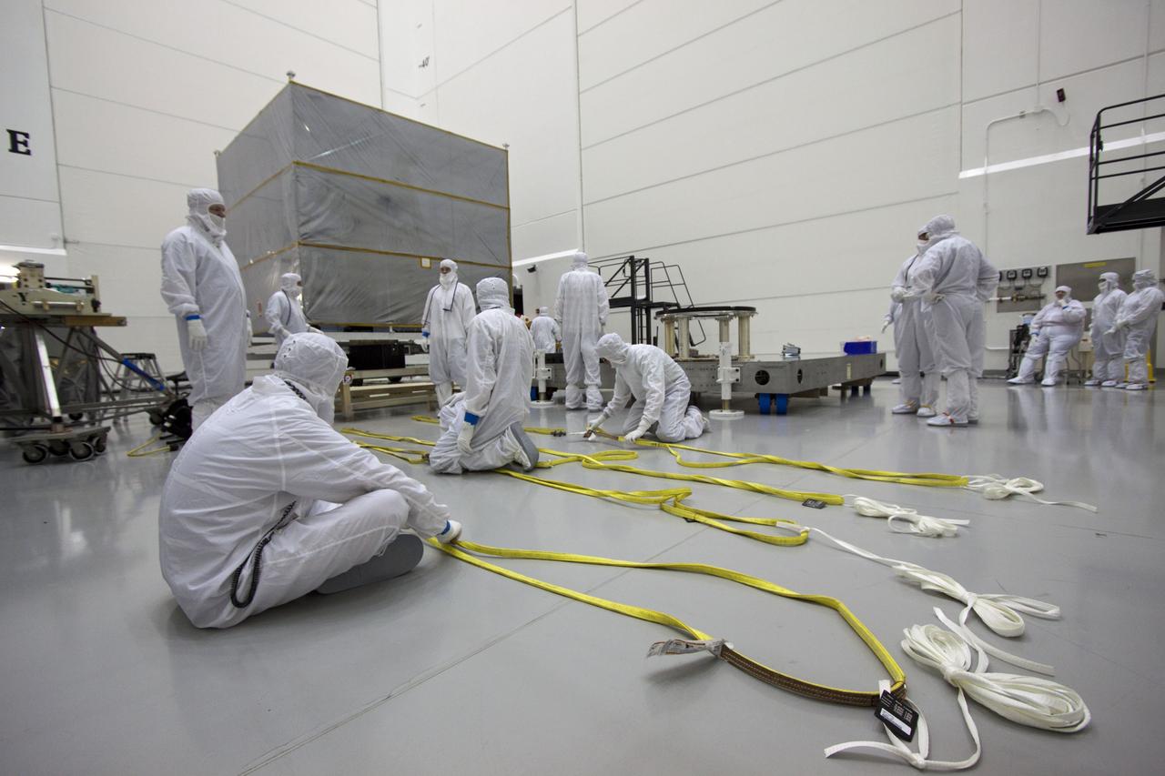 CAPE CANAVERAL, Fla. --  At Astrotech's Hazardous Processing Facility in Titusville, Fla.,  technicians prepare cable for an overhead crane to lift the cover from NASA's Juno spacecraft before its move to a fueling stand where the spacecraft will be loaded with the propellant necessary for orbit maneuvers and the attitude control system.      Juno is scheduled to launch aboard a United Launch Alliance Atlas V rocket from Cape Canaveral, Fla.,  Aug. 5.The solar-powered spacecraft will orbit Jupiter's poles 33 times to find out more about the gas giant's origins, structure, atmosphere and magnetosphere and investigate the existence of a solid planetary core. For more information visit: www.nasa.gov/juno. Photo credit: NASA/Troy Cryder