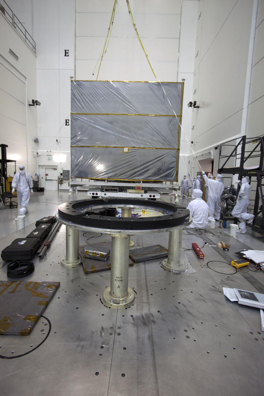 CAPE CANAVERAL, Fla. --  At Astrotech's Hazardous Processing Facility in Titusville, Fla.,  technicians use an overhead crane to lift the cover from NASA's Juno spacecraft before its move to a fueling stand where the spacecraft will be loaded with the propellant necessary for orbit maneuvers and the attitude control system.          Juno is scheduled to launch aboard a United Launch Alliance Atlas V rocket from Cape Canaveral, Fla.,  Aug. 5.The solar-powered spacecraft will orbit Jupiter's poles 33 times to find out more about the gas giant's origins, structure, atmosphere and magnetosphere and investigate the existence of a solid planetary core. For more information visit: www.nasa.gov/juno. Photo credit: NASA/Troy Cryder