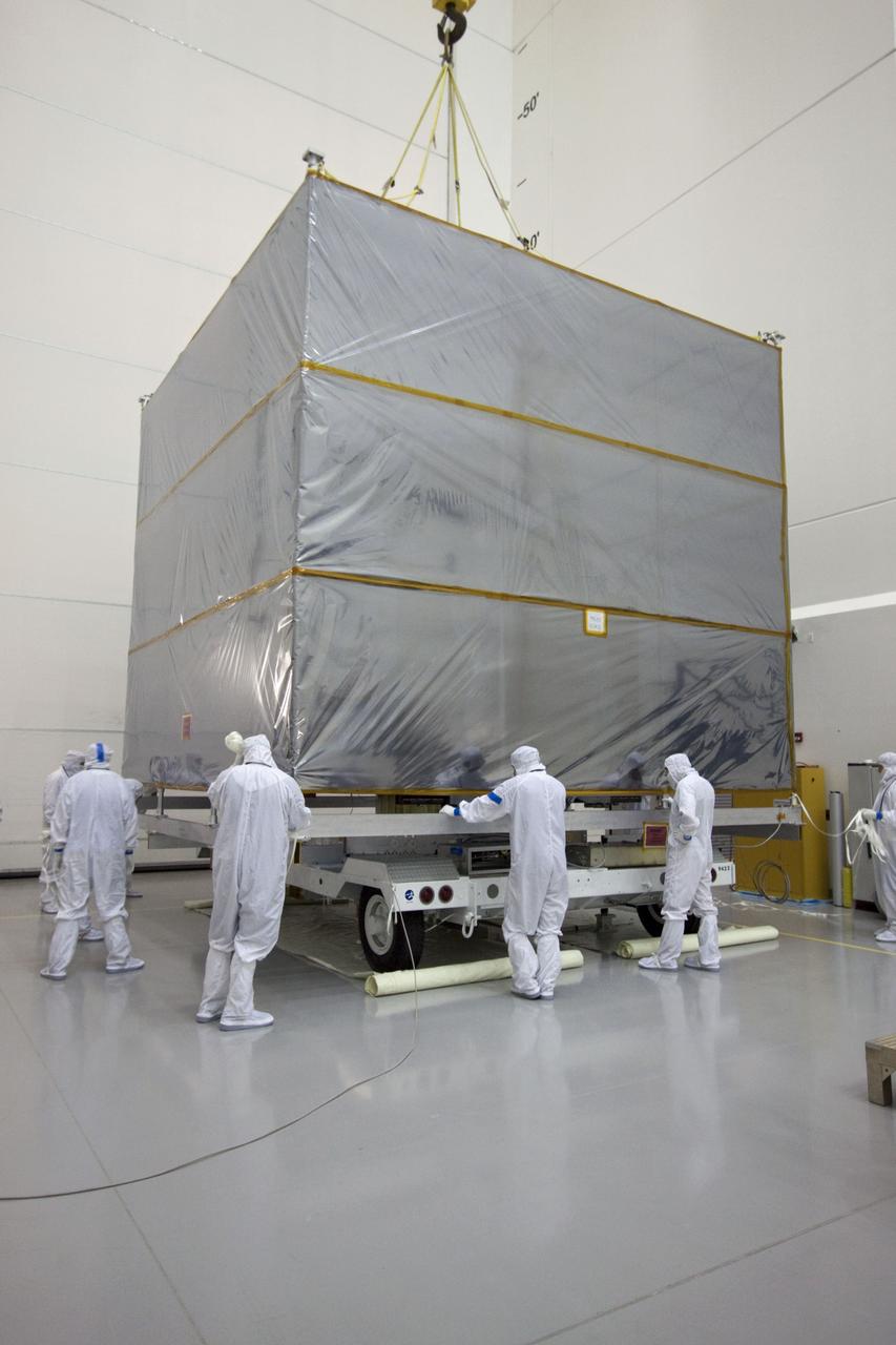 CAPE CANAVERAL, Fla. --  At Astrotech's Hazardous Processing Facility in Titusville, Fla.,  technicians use an overhead crane to lift the cover from NASA's Juno spacecraft before its move to a fueling stand where the spacecraft will be loaded with the propellant necessary for orbit maneuvers and the attitude control system.          Juno is scheduled to launch aboard a United Launch Alliance Atlas V rocket from Cape Canaveral, Fla.,  Aug. 5.The solar-powered spacecraft will orbit Jupiter's poles 33 times to find out more about the gas giant's origins, structure, atmosphere and magnetosphere and investigate the existence of a solid planetary core. For more information visit: www.nasa.gov/juno. Photo credit: NASA/Troy Cryder