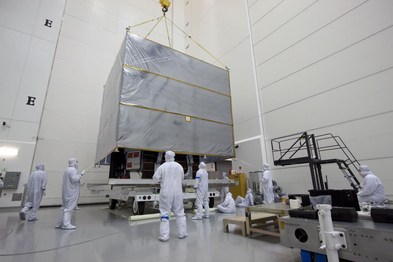 CAPE CANAVERAL, Fla. --  At Astrotech's Hazardous Processing Facility in Titusville, Fla.,  technicians use an overhead crane to lift the cover from NASA's Juno spacecraft before its move to a fueling stand where the spacecraft will be loaded with the propellant necessary for orbit maneuvers and the attitude control system.          Juno is scheduled to launch aboard a United Launch Alliance Atlas V rocket from Cape Canaveral, Fla.,  Aug. 5.The solar-powered spacecraft will orbit Jupiter's poles 33 times to find out more about the gas giant's origins, structure, atmosphere and magnetosphere and investigate the existence of a solid planetary core. For more information visit: www.nasa.gov/juno. Photo credit: NASA/Troy Cryder