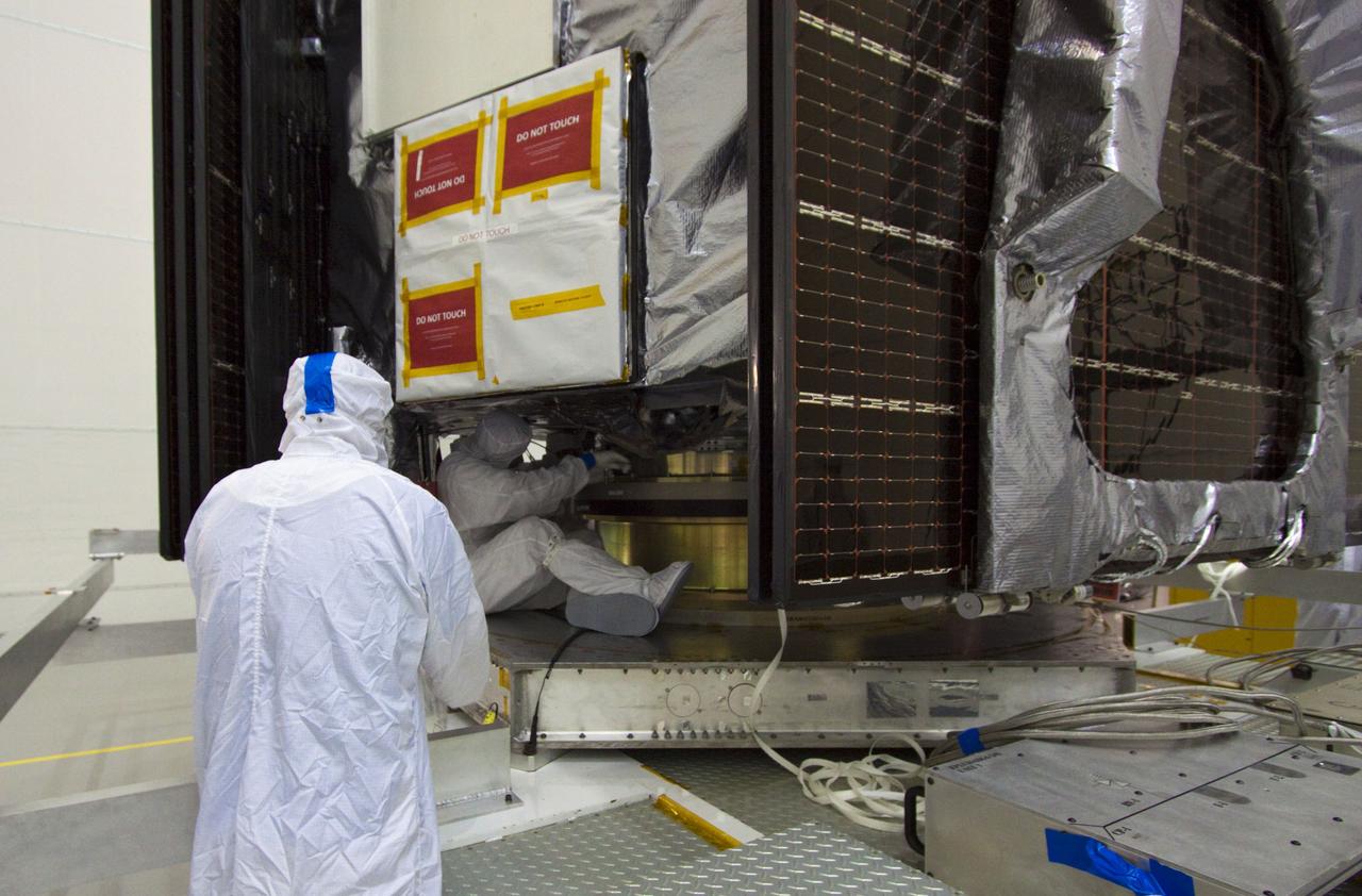 CAPE CANAVERAL, Fla. --  At Astrotech's Hazardous Processing Facility in Titusville, Fla.,  technicians disconnect NASA's Juno spacecraft from its transport prior to its move to a fueling stand where the spacecraft will be loaded with the propellant necessary for orbit maneuvers and the attitude control system.        Juno is scheduled to launch aboard a United Launch Alliance Atlas V rocket from Cape Canaveral, Fla.,  Aug. 5.The solar-powered spacecraft will orbit Jupiter's poles 33 times to find out more about the gas giant's origins, structure, atmosphere and magnetosphere and investigate the existence of a solid planetary core. For more information visit: www.nasa.gov/juno. Photo credit: NASA/Troy Cryder