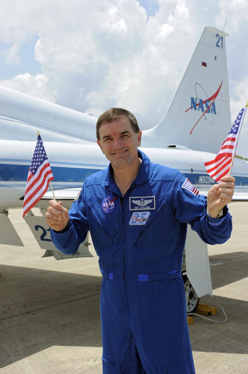 CAPE CANAVERAL, Fla. -- STS-135 Mission Specialists Rex Walheim waves the American flag to commemorate the U.S. Independence Day holiday after disembarking from a T-38 jet at the Shuttle Landing Facility at NASA's Kennedy Space Center in Florida. The STS-135 crew members arrived at Kennedy at about 2:30 p.m. EDT on July 4 for final preparations for space shuttle Atlantis' STS-135 mission to the International Space Station. Atlantis is scheduled to lift off on July 8 to deliver the Raffaello multi-purpose logistics module packed with supplies and spare parts to the station. The STS-135 mission also will fly a system to investigate the potential for robotically refueling existing satellites and return a failed ammonia pump module to help NASA better understand the failure mechanism and improve pump designs for future systems. STS-135 will be the 33rd flight of Atlantis, the 37th shuttle mission to the space station, and the 135th and final mission of NASA's Space Shuttle Program. For more information visit, www.nasa.gov/mission_pages/shuttle/shuttlemissions/sts135/index.html. Photo credit: NASA/Kim Shiflett