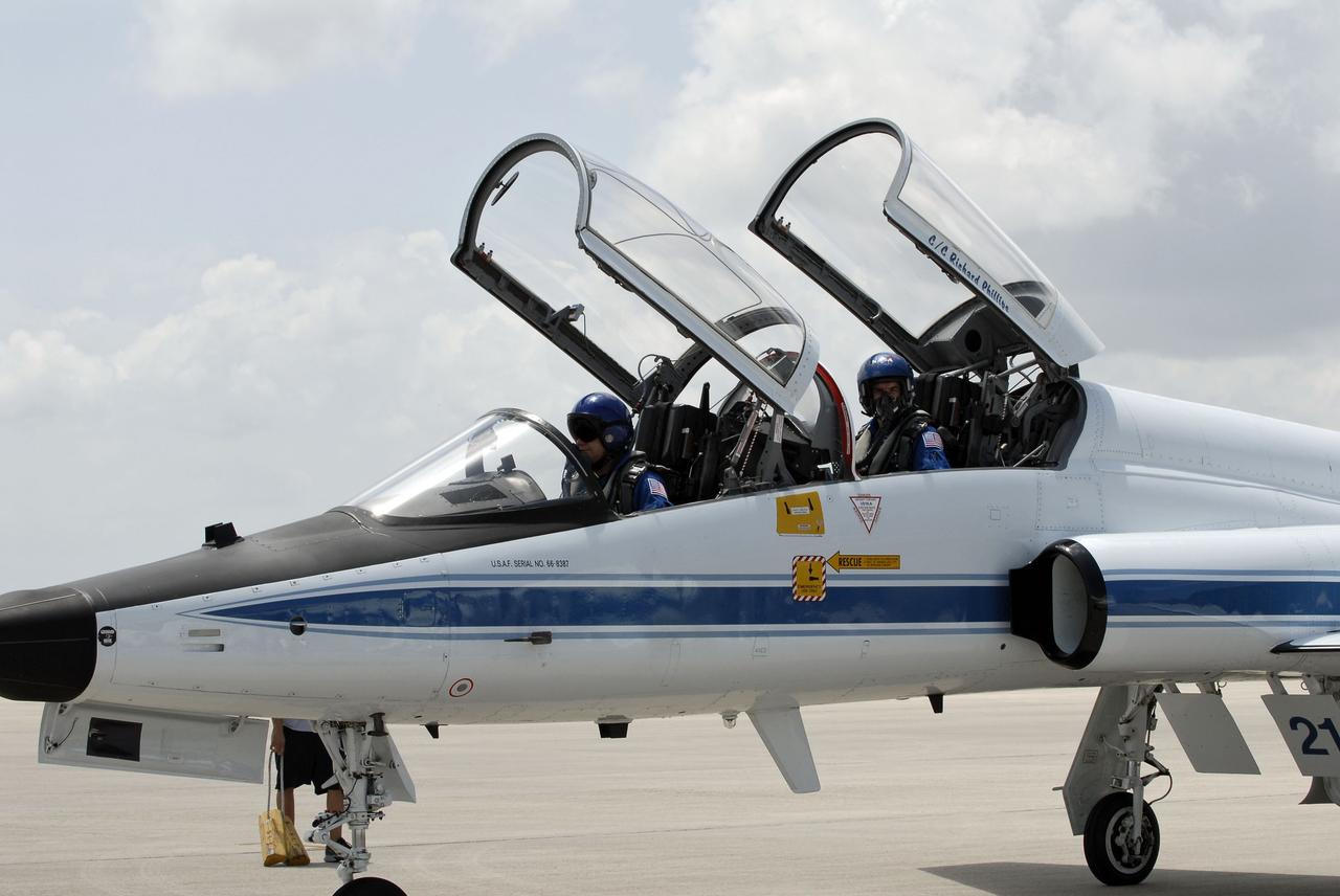 CAPE CANAVERAL, Fla. -- On the Shuttle Landing Facility at NASA's Kennedy Space Center in Florida, STS-135 Pilot Doug Hurley and Mission Specialist Rex Walheim are ready to disembark from a T-38 jet.        The STS-135 astronauts arrived at Kennedy about 2:30 p.m. EDT on July 4 for final preparations for space shuttle Atlantis' STS-135 mission to the International Space Station. Atlantis is scheduled to lift off on July 8 to deliver the Raffaello multi-purpose logistics module packed with supplies and spare parts to the station. The STS-135 mission also will fly a system to investigate the potential for robotically refueling existing satellites and return a failed ammonia pump module to help NASA better understand the failure mechanism and improve pump designs for future systems. STS-135 will be the 33rd flight of Atlantis, the 37th shuttle mission to the space station, and the 135th and final mission of NASA's Space Shuttle Program. For more information visit, www.nasa.gov/mission_pages/shuttle/shuttlemissions/sts135/index.html. Photo credit: NASA/Kim Shiflett
