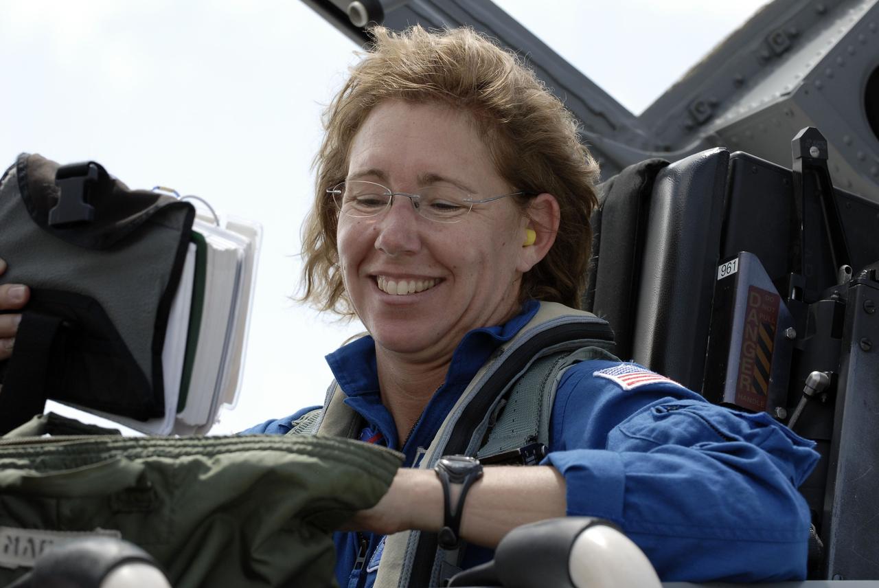 CAPE CANAVERAL, Fla. -- On the Shuttle Landing Facility at NASA's Kennedy Space Center in Florida, STS-135 Mission Specialist Sandy Magnus prepares to disembark from a T-38 jet. The STS-135 astronauts arrived at Kennedy about 2:30 p.m. EDT on July 4 for final preparations for space shuttle Atlantis' STS-135 mission to the International Space Station. Atlantis is scheduled to lift off on July 8 to deliver the Raffaello multi-purpose logistics module packed with supplies and spare parts to the station. The STS-135 mission also will fly a system to investigate the potential for robotically refueling existing satellites and return a failed ammonia pump module to help NASA better understand the failure mechanism and improve pump designs for future systems. STS-135 will be the 33rd flight of Atlantis, the 37th shuttle mission to the space station, and the 135th and final mission of NASA's Space Shuttle Program. For more information visit, www.nasa.gov/mission_pages/shuttle/shuttlemissions/sts135/index.html. Photo credit: NASA/Kim Shiflett
