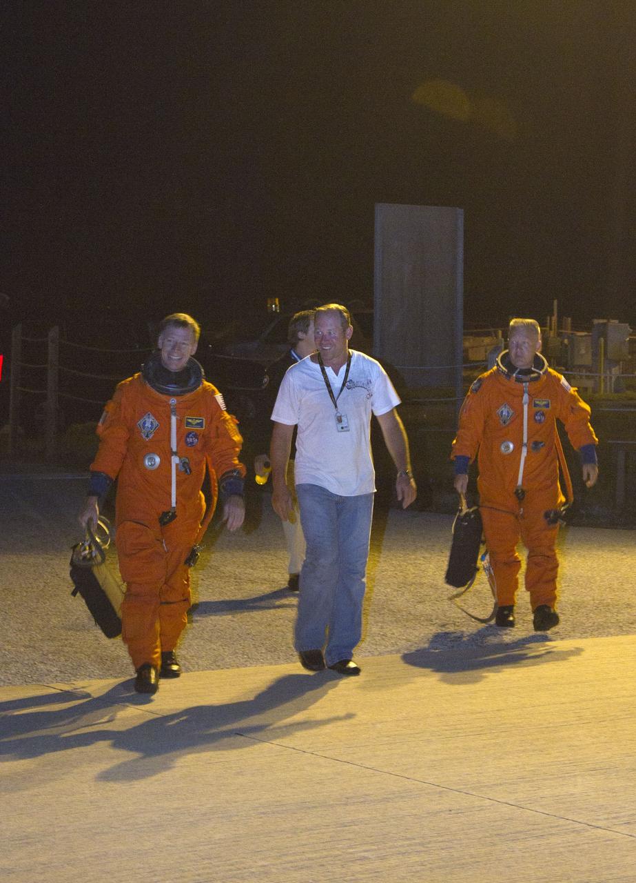 CAPE CANAVERAL, Fla. -- At NASA's Kennedy Space Center in Florida, STS-135 Commander Chris Ferguson (left) and Pilot Doug Hurley walk onto Kennedy's Shuttle Landing Facility to practice touch-and-go landings in a Shuttle Training Aircraft (STA). An STA is a Gulfstream II jet that is modified to mimic the shuttle's handling during the final phase of landing. Ferguson and Hurley will practice landings as part of standard procedure before space shuttle Atlantis' launch to the International Space Station. Atlantis and its crew are scheduled to lift off at 11:26 a.m. EDT on July 8 to deliver the Raffaello multi-purpose logistics module packed with supplies and spare parts to the station. The STS-135 mission also will fly a system to investigate the potential for robotically refueling existing satellites and return a failed ammonia pump module to help NASA better understand the failure mechanism and improve pump designs for future systems. STS-135 will be the 33rd flight of Atlantis, the 37th shuttle mission to the space station, and the 135th and final mission of NASA's Space Shuttle Program. For more information visit, www.nasa.gov/mission_pages/shuttle/shuttlemissions/sts135/index.html. Photo credit: NASA/Cory Huston