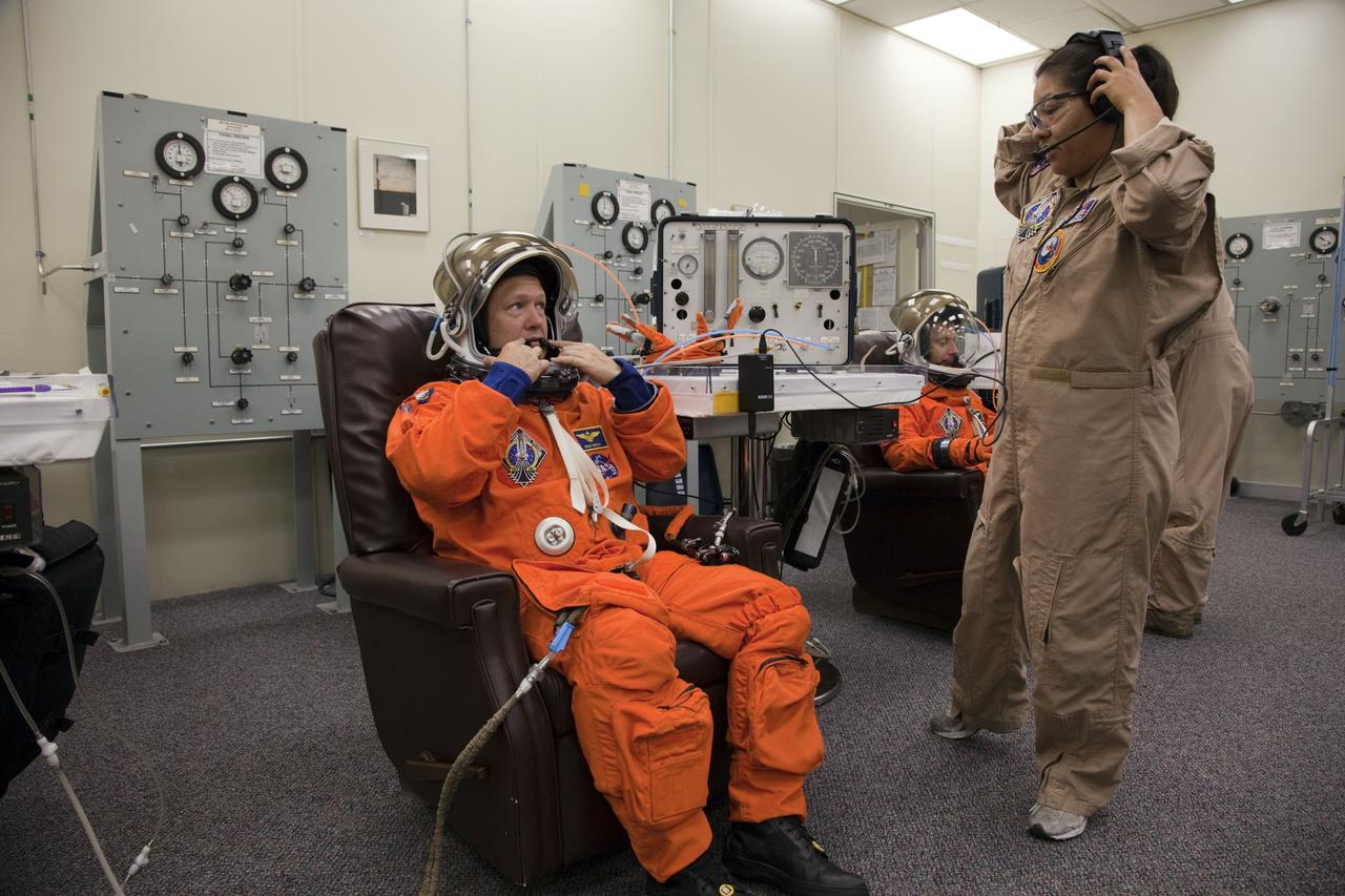 CAPE CANAVERAL, Fla. -- In the Operations and Checkout Building at NASA's Kennedy Space Center in Florida, STS-135 Pilot Doug Hurley has his launch-and-landing suit checked by suit technician Cathy Cruz, part of final preparations for space shuttle Atlantis' STS-135 mission to the International Space Station. Atlantis and its crew are scheduled to lift off at 11:26 a.m. EDT on July 8 to deliver the Raffaello multi-purpose logistics module packed with supplies and spare parts to the station. The STS-135 mission also will fly a system to investigate the potential for robotically refueling existing satellites and return a failed ammonia pump module to help NASA better understand the failure mechanism and improve pump designs for future systems. STS-135 will be the 33rd flight of Atlantis, the 37th shuttle mission to the space station, and the 135th and final mission of NASA's Space Shuttle Program. For more information visit, www.nasa.gov/mission_pages/shuttle/shuttlemissions/sts135/index.html. Photo credit: NASA/Cory Huston