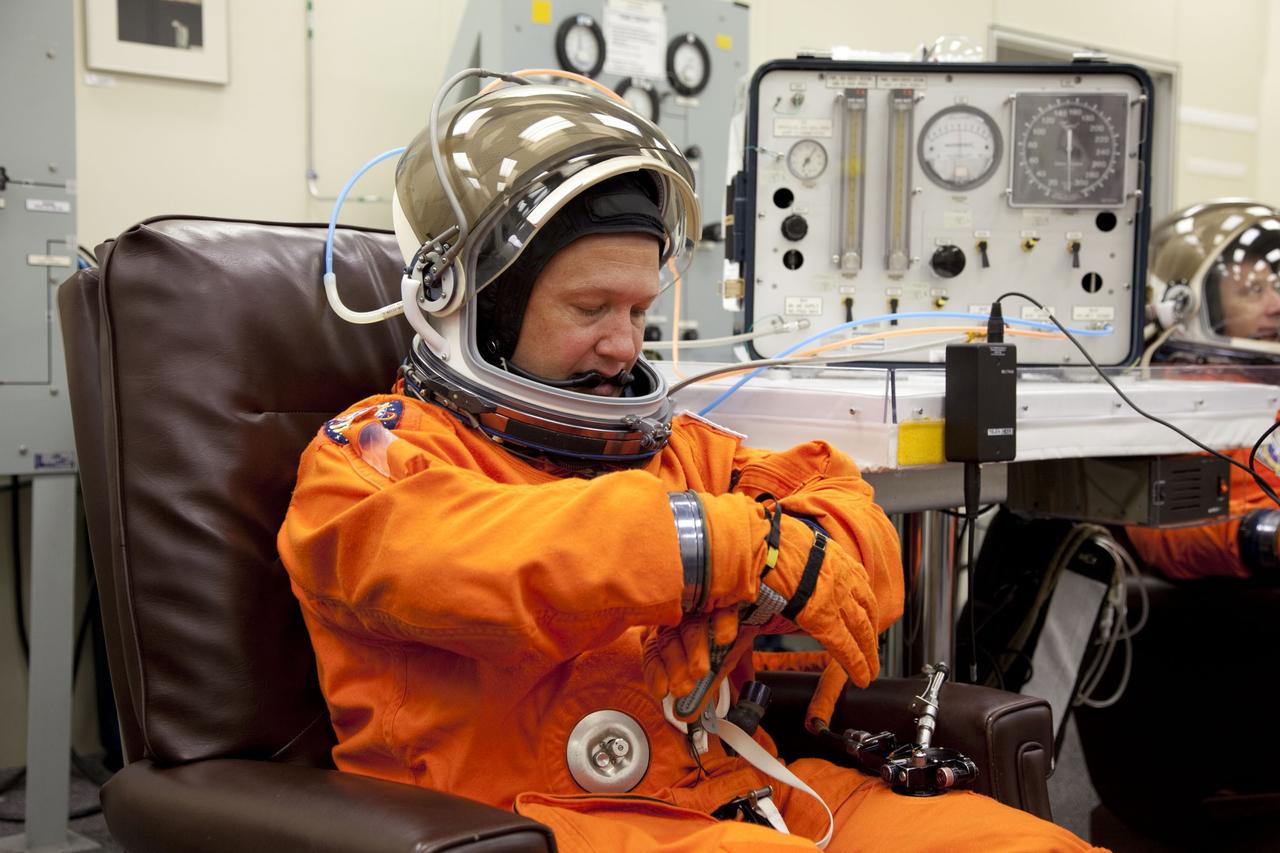 CAPE CANAVERAL, Fla. -- In the Operations and Checkout Building at NASA's Kennedy Space Center in Florida, STS-135 Pilot Doug Hurley checks the fit of his launch-and-landing suit, part of final preparations for space shuttle Atlantis' STS-135 mission to the International Space Station. Atlantis and its crew are scheduled to lift off at 11:26 a.m. EDT on July 8 to deliver the Raffaello multi-purpose logistics module packed with supplies and spare parts to the station. The STS-135 mission also will fly a system to investigate the potential for robotically refueling existing satellites and return a failed ammonia pump module to help NASA better understand the failure mechanism and improve pump designs for future systems. STS-135 will be the 33rd flight of Atlantis, the 37th shuttle mission to the space station, and the 135th and final mission of NASA's Space Shuttle Program. For more information visit, www.nasa.gov/mission_pages/shuttle/shuttlemissions/sts135/index.html. Photo credit: NASA/Cory Huston
