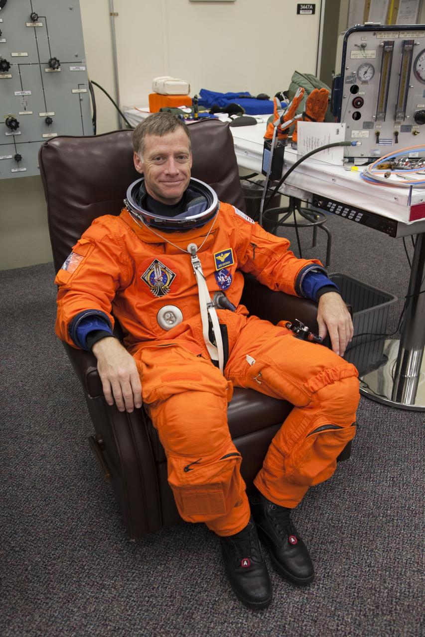 CAPE CANAVERAL, Fla. -- In the Operations and Checkout Building at NASA's Kennedy Space Center in Florida, STS-135 Commander Chris Ferguson pauses for a photo after checking the fit of his launch-and-landing suit, part of final preparations for space shuttle Atlantis' STS-135 mission to the International Space Station. Atlantis and its crew are scheduled to lift off at 11:26 a.m. EDT on July 8 to deliver the Raffaello multi-purpose logistics module packed with supplies and spare parts to the station. The STS-135 mission also will fly a system to investigate the potential for robotically refueling existing satellites and return a failed ammonia pump module to help NASA better understand the failure mechanism and improve pump designs for future systems. STS-135 will be the 33rd flight of Atlantis, the 37th shuttle mission to the space station, and the 135th and final mission of NASA's Space Shuttle Program. For more information visit, www.nasa.gov/mission_pages/shuttle/shuttlemissions/sts135/index.html. Photo credit: NASA/Cory Huston