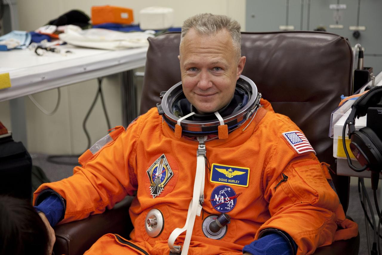 CAPE CANAVERAL, Fla. -- In the Operations and Checkout Building at NASA's Kennedy Space Center in Florida, STS-135 Pilot Doug Hurley pauses for a photo after checking the fit of his launch-and-landing suit, part of final preparations for space shuttle Atlantis' STS-135 mission to the International Space Station. Atlantis and its crew are scheduled to lift off at 11:26 a.m. EDT on July 8 to deliver the Raffaello multi-purpose logistics module packed with supplies and spare parts to the station. The STS-135 mission also will fly a system to investigate the potential for robotically refueling existing satellites and return a failed ammonia pump module to help NASA better understand the failure mechanism and improve pump designs for future systems. STS-135 will be the 33rd flight of Atlantis, the 37th shuttle mission to the space station, and the 135th and final mission of NASA's Space Shuttle Program. For more information visit, www.nasa.gov/mission_pages/shuttle/shuttlemissions/sts135/index.html. Photo credit: NASA/Cory Huston