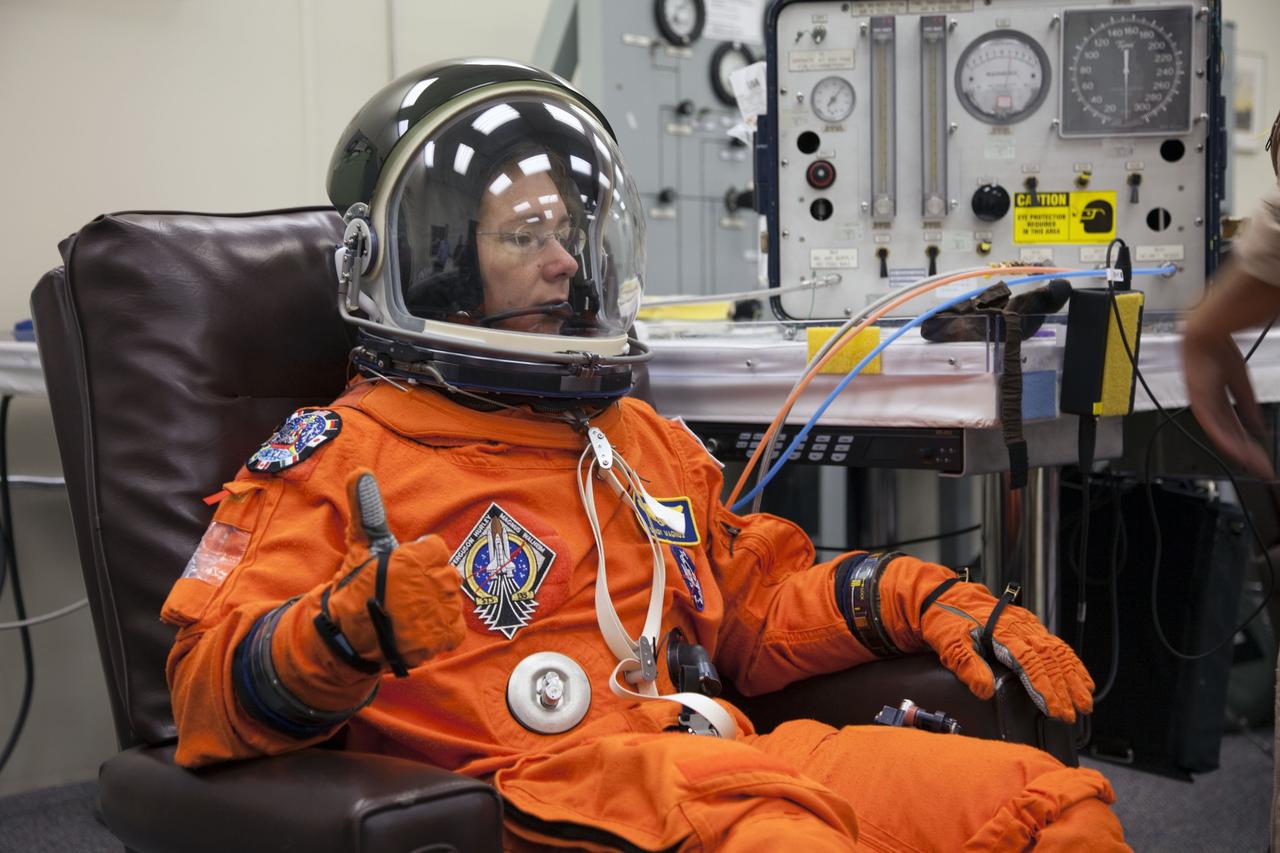 CAPE CANAVERAL, Fla. -- In the Operations and Checkout Building at NASA's Kennedy Space Center in Florida, STS-135 Mission Specialist Sandy Magnus gives a thumbs-up after checking the fit of her launch-and-landing suit, part of final preparations for space shuttle Atlantis' STS-135 mission to the International Space Station. Atlantis and its crew are scheduled to lift off at 11:26 a.m. EDT on July 8 to deliver the Raffaello multi-purpose logistics module packed with supplies and spare parts to the station. The STS-135 mission also will fly a system to investigate the potential for robotically refueling existing satellites and return a failed ammonia pump module to help NASA better understand the failure mechanism and improve pump designs for future systems. STS-135 will be the 33rd flight of Atlantis, the 37th shuttle mission to the space station, and the 135th and final mission of NASA's Space Shuttle Program. For more information visit, www.nasa.gov/mission_pages/shuttle/shuttlemissions/sts135/index.html. Photo credit: NASA/Cory Huston