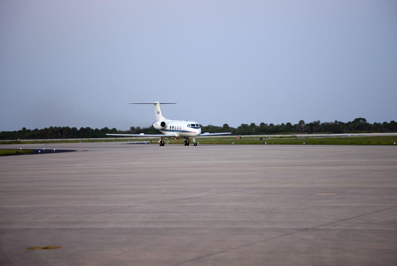 CAPE CANAVERAL, Fla. -- STS-135 Commander Chris Ferguson and Pilot Doug Hurley return after performing touch-and-go landings aboard a Shuttle Training Aircraft (STA) on the Shuttle Landing Facility runway at NASA's Kennedy Space Center in Florida. An STA is a Gulfstream II jet that is modified to mimic the shuttle's handling during the final phase of landing. Ferguson and Hurley practice landings as part of standard procedure before space shuttle Atlantis' launch to the International Space Station. Atlantis and its crew are scheduled to lift off at 11:26 a.m. EDT on July 8 to deliver the Raffaello multi-purpose logistics module packed with supplies and spare parts to the station. The STS-135 mission also will fly a system to investigate the potential for robotically refueling existing satellites and return a failed ammonia pump module to help NASA better understand the failure mechanism and improve pump designs for future systems. STS-135 will be the 33rd flight of Atlantis, the 37th shuttle mission to the space station, and the 135th and final mission of NASA's Space Shuttle Program. For more information visit, www.nasa.gov/mission_pages/shuttle/shuttlemissions/sts135/index.html. Photo credit: NASA/Cory Huston