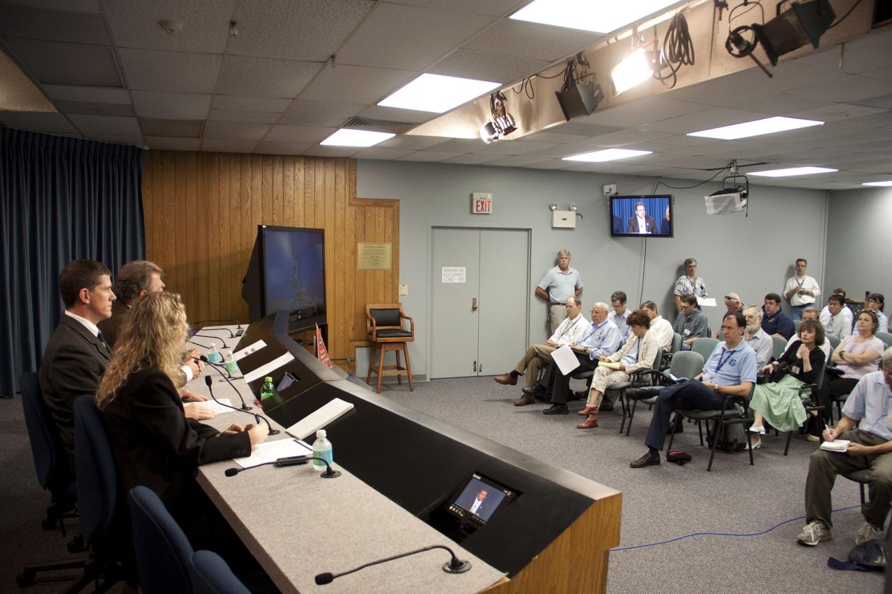 CAPE CANAVERAL, Fla. -- In the Press Site auditorium at NASA's Kennedy Space Center in Florida, NASA managers brief media about the payload and launch status of space shuttle Atlantis' STS-135 mission to the International Space Station. Seen here are Public Affairs Officer Candrea Thomas, NASA Test Director Jeremy Graeber, Payload Mission Manager Joe Delai and Shuttle Weather Officer Kathy Winters (obscured).        Atlantis and its crew are scheduled to lift off at 11:26 a.m. EDT on July 8 to deliver the Raffaello multi-purpose logistics module packed with supplies and spare parts to the station. The STS-135 mission also will fly a system to investigate the potential for robotically refueling existing satellites and return a failed ammonia pump module to help NASA better understand the failure mechanism and improve pump designs for future systems. STS-135 will be the 33rd flight of Atlantis, the 37th shuttle mission to the space station, and the 135th and final mission of NASA's Space Shuttle Program. For more information visit, www.nasa.gov/mission_pages/shuttle/shuttlemissions/sts135/index.html. Photo credit: NASA/Jim Grossmann