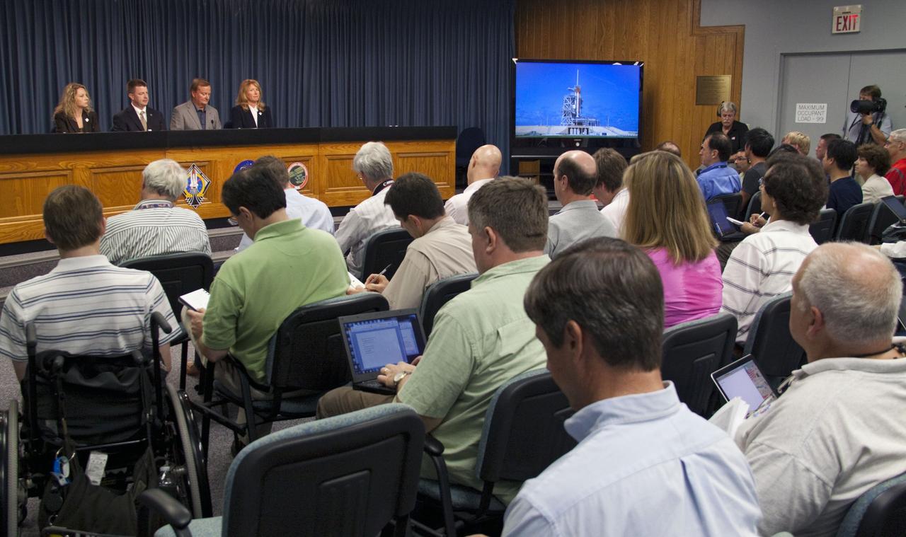 CAPE CANAVERAL, Fla. -- In the Press Site auditorium at NASA's Kennedy Space Center in Florida, NASA managers brief media about the launch status of space shuttle Atlantis' STS-135 mission to the International Space Station. Seen here are Public Affairs Officer Candrea Thomas (left), Space Shuttle Program Launch Integration Manager Mike Moses, Shuttle Launch Director Mike Leinbach and Shuttle Weather Officer Kathy Winters.            Atlantis and its crew of four are scheduled to lift off at 11:26 a.m. EDT on July 8 to deliver the Raffaello multi-purpose logistics module packed with supplies and spare parts to the station. The STS-135 mission also will fly a system to investigate the potential for robotically refueling existing satellites and return a failed ammonia pump module to help NASA better understand the failure mechanism and improve pump designs for future systems. STS-135 will be the 33rd flight of Atlantis, the 37th shuttle mission to the space station, and the 135th and final mission of NASA's Space Shuttle Program. For more information visit, www.nasa.gov/mission_pages/shuttle/shuttlemissions/sts135/index.html. Photo credit: NASA/Jack Pfaller