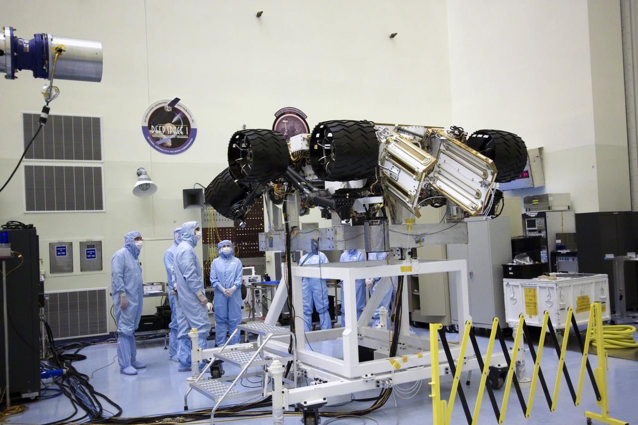 Cape Canaveral, Fla. - NASA Deputy Administrator Lori Garver, fourth from left, looks over NASA's Mars Science Laboratory (MSL) rover known as Curiosity as it sits in a workstand at the Payload Hazardous Servicing Facility at NASA's Kennedy Space Center in Florida. A United Launch Alliance Atlas V-541 configuration will be used to loft MSL into space. Curiosity’s 10 science instruments are designed to search for evidence on whether Mars has had environments favorable to microbial life, including chemical ingredients for life. The unique rover will use a laser to look inside rocks and release its gasses so that the rover’s spectrometer can analyze and send the data back to Earth. MSL is scheduled to launch from Cape Canaveral Air Force Station in Florida Nov. 25 with a window extending to Dec. 18 and arrival at Mars Aug. 2012. For more information, visit http://www.nasa.gov/msl. Photo credit: NASA/Jim Grossmann