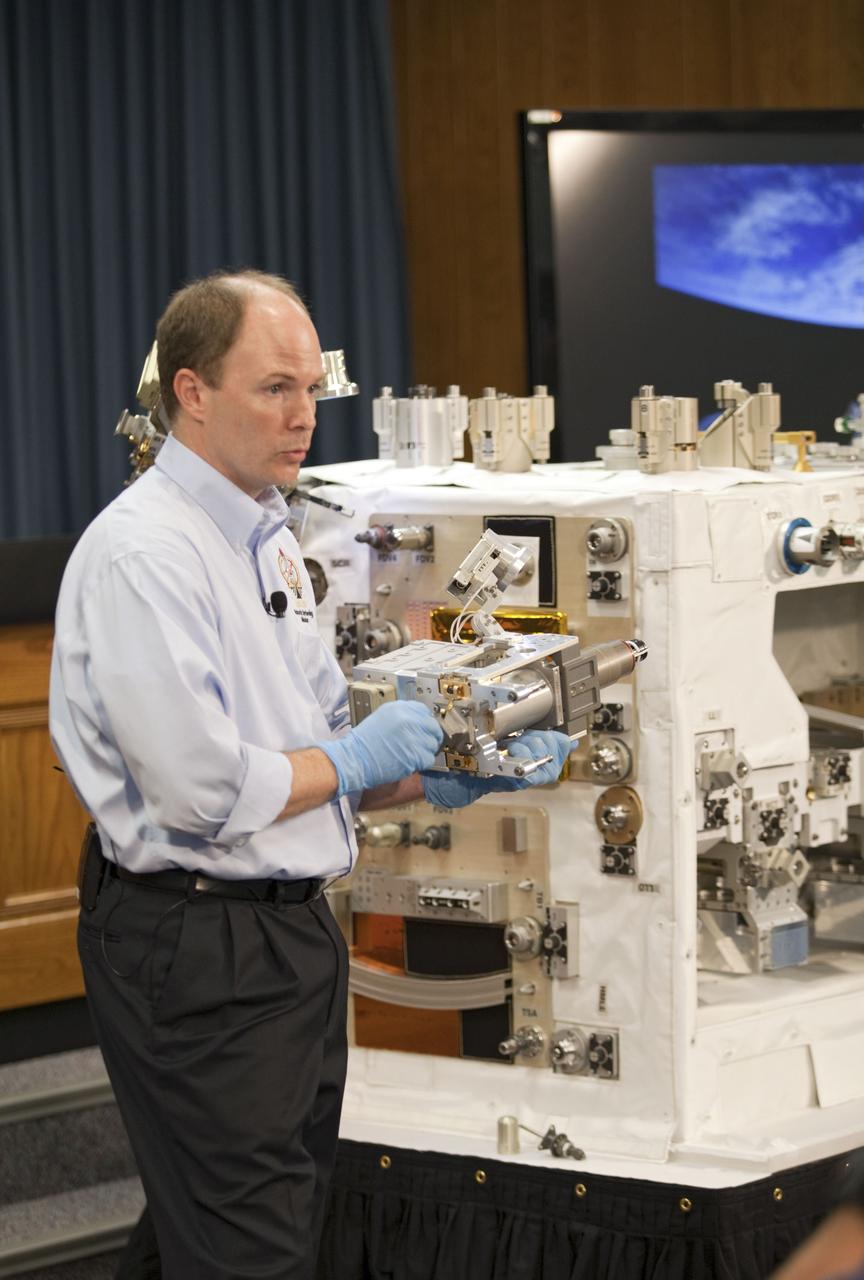 CAPE CANAVERAL, Fla. -- The Press Site auditorium at NASA's Kennedy Space Center in Florida hosted a Robotic Refueling Mission (RRM) module demonstration. Seen here is Benjamin Reed, deputy project manager with NASA's Satellite Servicing Capabilities Office, giving media an overview of the RRM. Space shuttle Atlantis will fly the RRM on its STS-135 mission to the International Space Station. Once in place, the RRM will use the station's two-armed robotic system, known as Dextre, to investigate the potential for robotically refueling existing satellites in orbit. Atlantis and its crew of four are scheduled to lift off at 11:26 a.m. EDT on July 8 to deliver the Raffaello multi-purpose logistics module packed with supplies and spare parts to the station. Atlantis also will fly the RRM and return a failed ammonia pump module to help NASA better understand the failure mechanism and improve pump designs for future systems. STS-135 will be the 33rd flight of Atlantis, the 37th shuttle mission to the space station, and the 135th and final mission of NASA's Space Shuttle Program. For more information visit, www.nasa.gov/mission_pages/shuttle/shuttlemissions/sts135/index.html. Photo credit: NASA/Frankie Martin