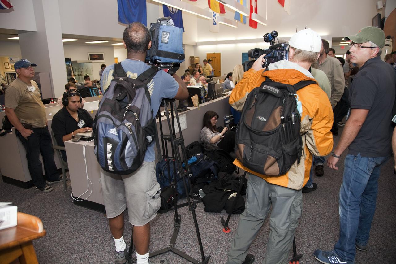CAPE CANAVERAL, Fla. -- Media from around the globe gather at the Press Site bull pen at NASA's Kennedy Space Center in Florida to cover the prelaunch activities and lift off of space shuttle Atlantis on its STS-135 mission to the International Space Station.         Atlantis and its crew of four; Commander Chris Ferguson, Pilot Doug Hurley and Mission Specialists Sandy Magnus and Rex Walheim, are scheduled to lift off at 11:26 a.m. EDT on July 8 to deliver the Raffaello multi-purpose logistics module packed with supplies and spare parts to the station. Atlantis also will fly the Robotic Refueling Mission experiment that will investigate the potential for robotically refueling existing satellites in orbit. In addition, Atlantis will return with a failed ammonia pump module to help NASA better understand the failure mechanism and improve pump designs for future systems. STS-135 will be the 33rd flight of Atlantis, the 37th shuttle mission to the space station, and the 135th and final mission of NASA's Space Shuttle Program. For more information visit, www.nasa.gov/mission_pages/shuttle/shuttlemissions/sts135/index.html. Photo credit: NASA/Frankie Martin