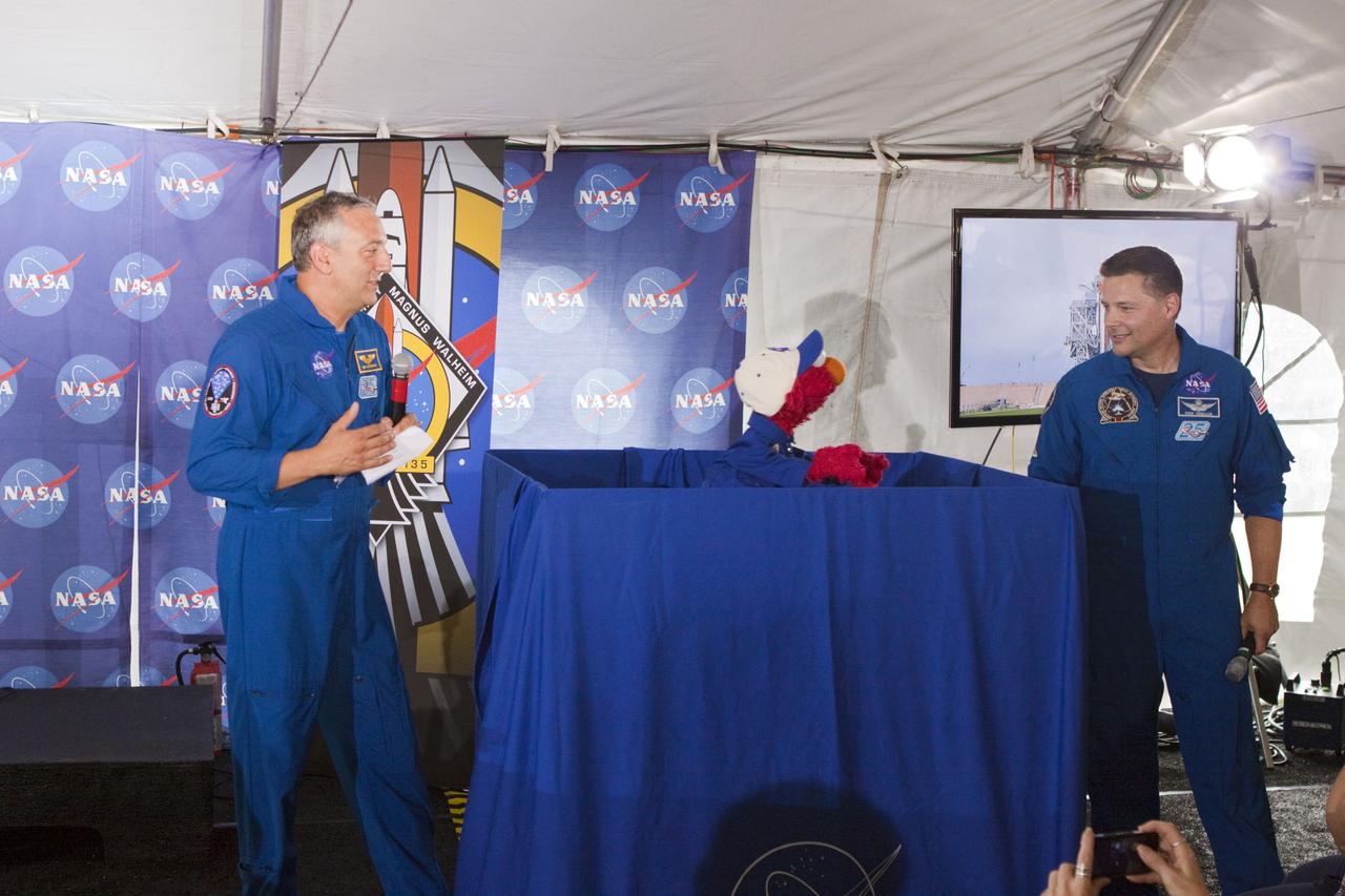 CAPE CANAVERAL, Fla. -- At Kennedy Space Center in Florida, NASA is hosting a Tweetup for 150 Twitter followers of space shuttle Atlantis' STS-135 mission to the International Space Station, selected from more than 5,500 online registrants. A Tweetup is an informal meeting of people who use the social messaging medium Twitter. Here, NASA astronauts Mike Massimino and Doug Wheelock talk with Sesame Street's Elmo. Sesame Street also is at Kennedy to film Elmo, as he learns about space exploration at NASA.        Atlantis and its crew of four; Commander Chris Ferguson, Pilot Doug Hurley, Mission Specialists Sandy Magnus and Rex Walheim, are scheduled to lift off at 11:26 a.m. EDT on July 8 to deliver the Raffaello multi-purpose logistics module packed with supplies and spare parts to the station. Atlantis also will fly the Robotic Refueling Mission experiment that will investigate the potential for robotically refueling existing satellites in orbit. In addition, Atlantis will return with a failed ammonia pump module to help NASA better understand the failure mechanism and improve pump designs for future systems. STS-135 will be the 33rd flight of Atlantis, the 37th shuttle mission to the space station, and the 135th and final mission of NASA's Space Shuttle Program. For more information visit, www.nasa.gov/mission_pages/shuttle/shuttlemissions/sts135/index.html. Photo credit: NASA/Troy Cryder