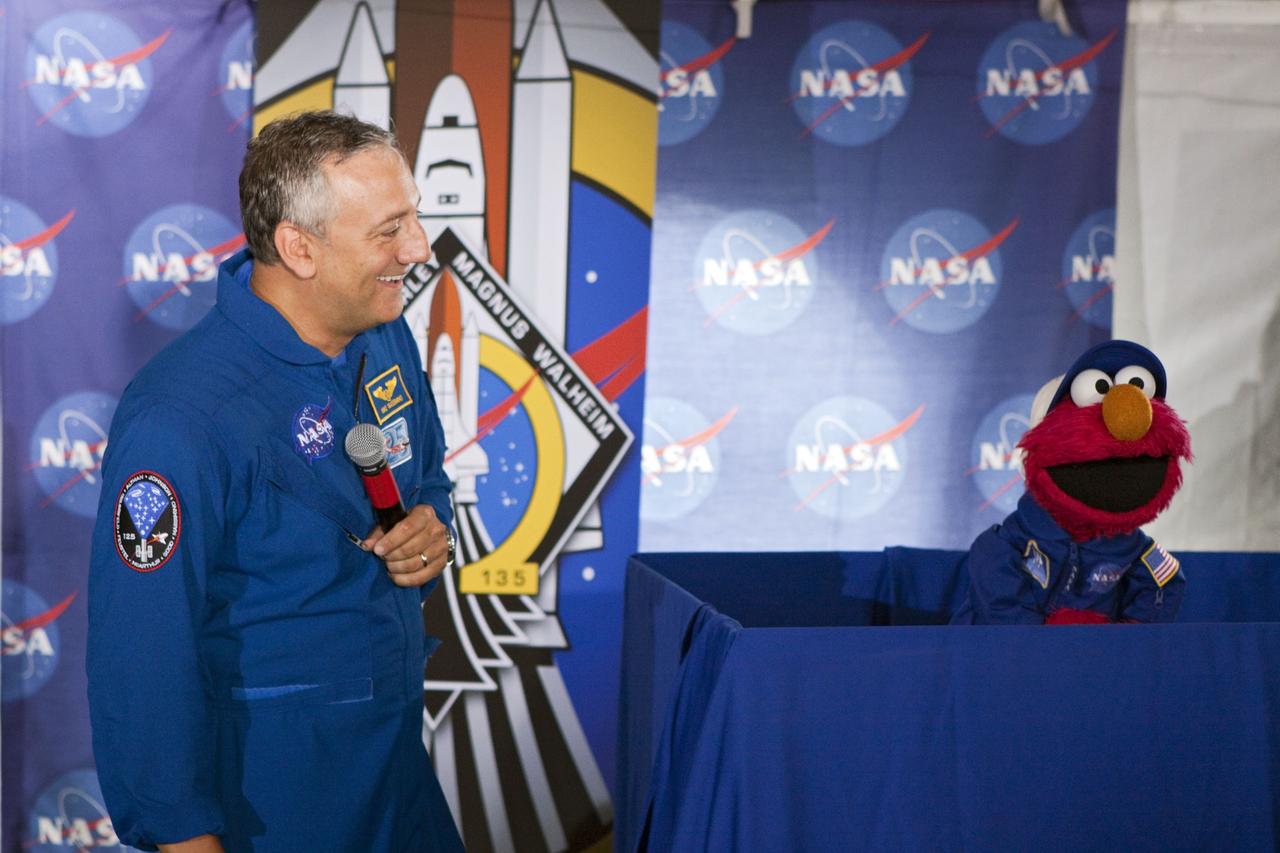 CAPE CANAVERAL, Fla. -- At Kennedy Space Center in Florida, NASA is hosting a Tweetup for 150 Twitter followers of space shuttle Atlantis' STS-135 mission to the International Space Station, selected from more than 5,500 online registrants. A Tweetup is an informal meeting of people who use the social messaging medium Twitter. Here, NASA astronaut Mike Massimino talks with Sesame Street's Elmo. Sesame Street also is at Kennedy to film Elmo, as he learns about space exploration at NASA.    Atlantis and its crew of four; Commander Chris Ferguson, Pilot Doug Hurley, Mission Specialists Sandy Magnus and Rex Walheim, are scheduled to lift off at 11:26 a.m. EDT on July 8 to deliver the Raffaello multi-purpose logistics module packed with supplies and spare parts to the station. Atlantis also will fly the Robotic Refueling Mission experiment that will investigate the potential for robotically refueling existing satellites in orbit. In addition, Atlantis will return with a failed ammonia pump module to help NASA better understand the failure mechanism and improve pump designs for future systems. STS-135 will be the 33rd flight of Atlantis, the 37th shuttle mission to the space station, and the 135th and final mission of NASA's Space Shuttle Program. For more information visit, www.nasa.gov/mission_pages/shuttle/shuttlemissions/sts135/index.html. Photo credit: NASA/Troy Cryder