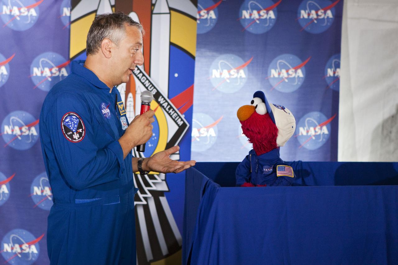 CAPE CANAVERAL, Fla. -- At Kennedy Space Center in Florida, NASA is hosting a Tweetup for 150 Twitter followers of space shuttle Atlantis' STS-135 mission to the International Space Station, selected from more than 5,500 online registrants. A Tweetup is an informal meeting of people who use the social messaging medium Twitter. Here, NASA astronaut Mike Massimino talks with Sesame Street's Elmo. Sesame Street also is at Kennedy to film Elmo, as he learns about space exploration at NASA.    Atlantis and its crew of four; Commander Chris Ferguson, Pilot Doug Hurley, Mission Specialists Sandy Magnus and Rex Walheim, are scheduled to lift off at 11:26 a.m. EDT on July 8 to deliver the Raffaello multi-purpose logistics module packed with supplies and spare parts to the station. Atlantis also will fly the Robotic Refueling Mission experiment that will investigate the potential for robotically refueling existing satellites in orbit. In addition, Atlantis will return with a failed ammonia pump module to help NASA better understand the failure mechanism and improve pump designs for future systems. STS-135 will be the 33rd flight of Atlantis, the 37th shuttle mission to the space station, and the 135th and final mission of NASA's Space Shuttle Program. For more information visit, www.nasa.gov/mission_pages/shuttle/shuttlemissions/sts135/index.html. Photo credit: NASA/Troy Cryder