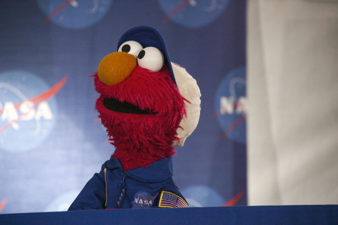 CAPE CANAVERAL, Fla. -- At Kennedy Space Center in Florida, NASA is hosting a Tweetup for 150 Twitter followers of space shuttle Atlantis' STS-135 mission to the International Space Station, selected from more than 5,500 online registrants. A Tweetup is an informal meeting of people who use the social messaging medium Twitter. Here, Sesame Street's Elmo listens to NASA astronaut Mike Massimino (out of frame), as he learns about space exploration at NASA.          Atlantis and its crew of four; Commander Chris Ferguson, Pilot Doug Hurley, Mission Specialists Sandy Magnus and Rex Walheim, are scheduled to lift off at 11:26 a.m. EDT on July 8 to deliver the Raffaello multi-purpose logistics module packed with supplies and spare parts to the station. Atlantis also will fly the Robotic Refueling Mission experiment that will investigate the potential for robotically refueling existing satellites in orbit. In addition, Atlantis will return with a failed ammonia pump module to help NASA better understand the failure mechanism and improve pump designs for future systems. STS-135 will be the 33rd flight of Atlantis, the 37th shuttle mission to the space station, and the 135th and final mission of NASA's Space Shuttle Program. For more information visit, www.nasa.gov/mission_pages/shuttle/shuttlemissions/sts135/index.html. Photo credit: NASA/Troy Cryder