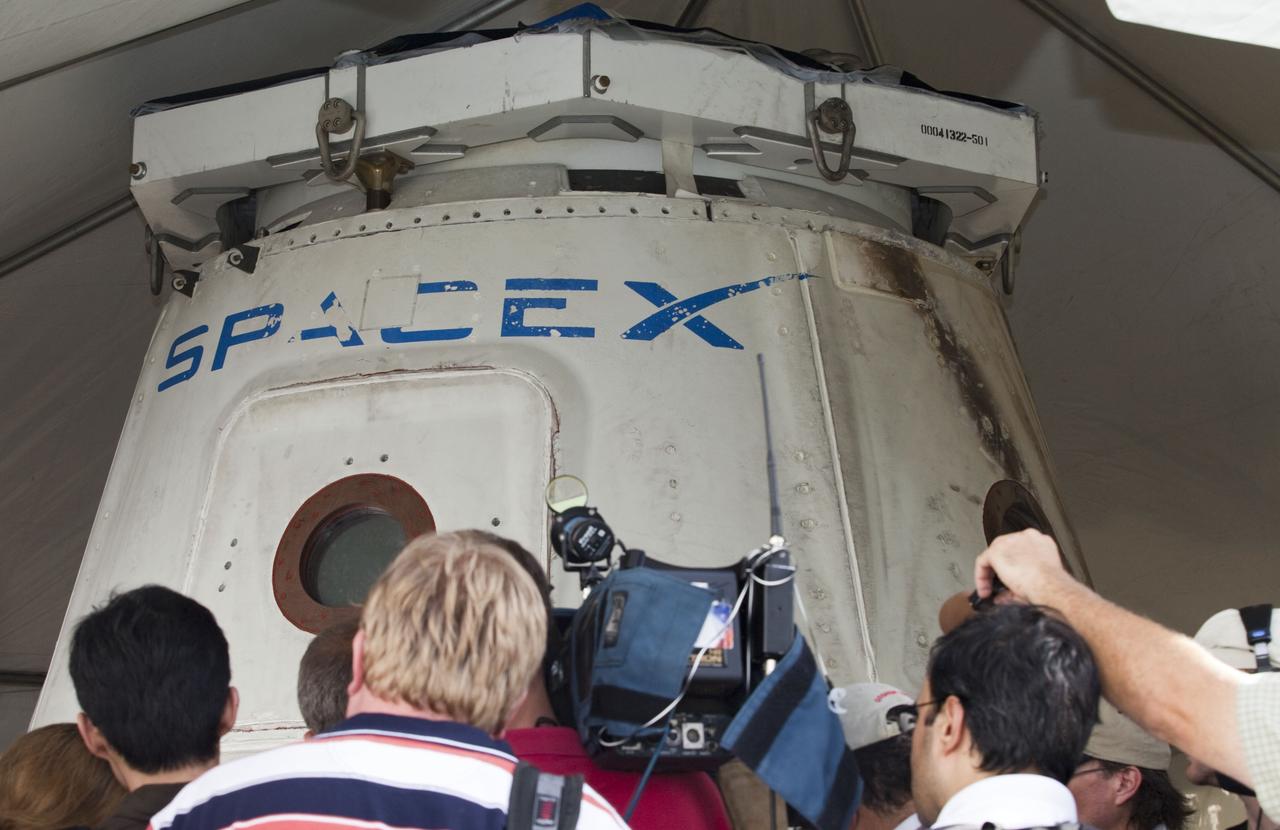 CAPE CANAVERAL, Fla. -- Space Exploration Technologies Corp., or SpaceX, displays a mock-up of its Dragon capsule during a media tour at Cape Canaveral Air Force Station, or CCAFS, in Florida.    In December 2010, SpaceX launched its Falcon 9 rocket and Dragon spacecraft from CCAFS's Launch Complex 40. The Dragon capsule went through several maneuvers before it re-entered the atmosphere and splashed down in the Pacific Ocean about 500 miles west of the coast of Mexico. That was the first demonstration flight for NASA's Commercial Orbital Transportation Services (COTS) program, which will provide cargo flights to the International Space Station in the future. The company is preparing for another launch in late 2011, in which the Dragon spacecraft and trunk will fly close to the space station so the station’s robotic arm can grab the spacecraft and bring it in for a docking.  Photo credit: NASA/Frankie Martin