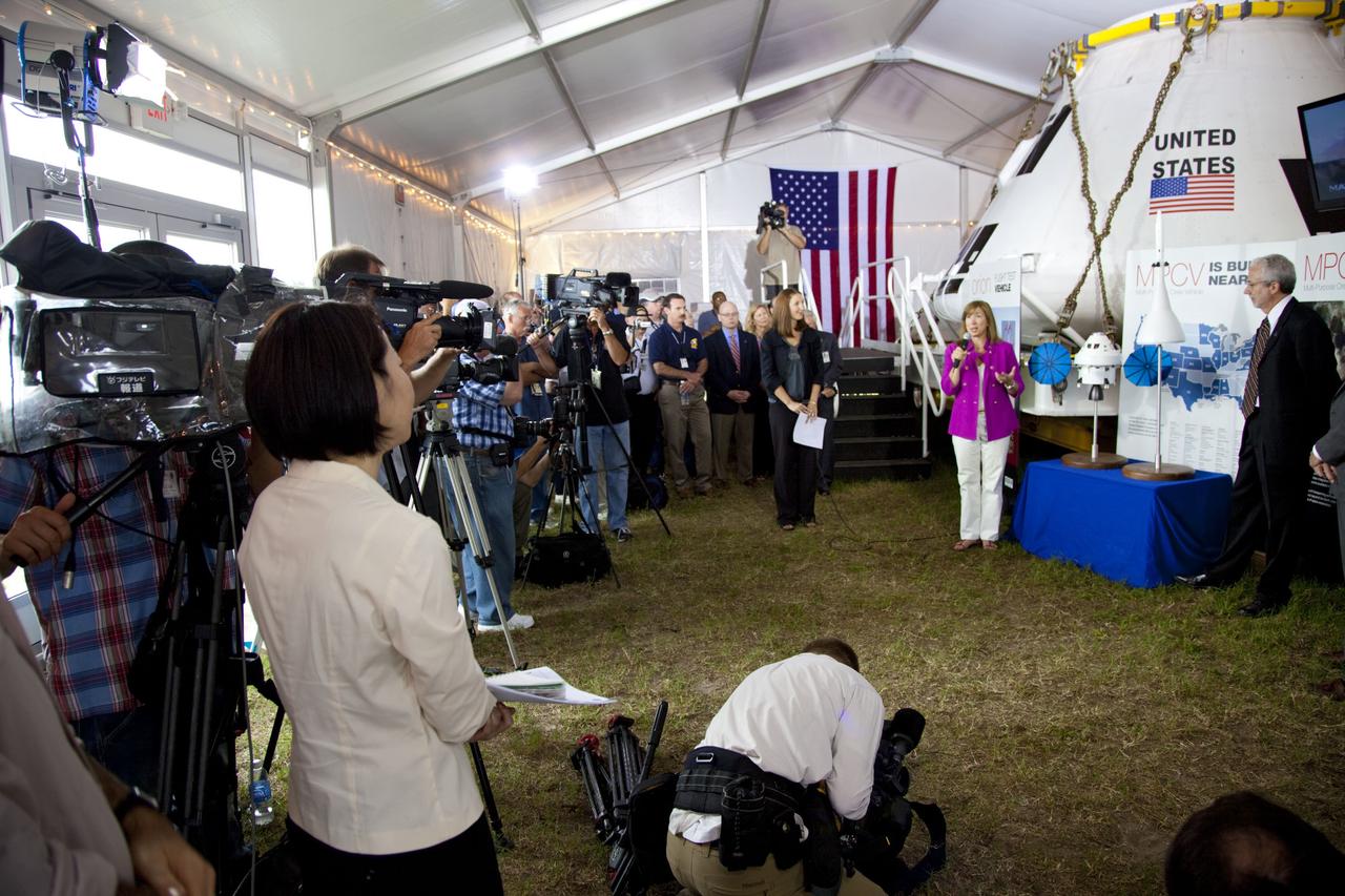 CAPE CANAVERAL, Fla. -- A media event was held on the grounds near the Press Site at NASA's Kennedy Space Center in Florida where a Multi-Purpose Crew Vehicle (MPCV) is on display. The MPCV is based on the Orion design requirements for traveling beyond low Earth orbit and will serve as the exploration vehicle that will carry the crew to space, provide emergency abort capability, sustain the crew during the space travel, and provide safe re-entry from deep space return velocities. Seen here is Public Affairs Officer Amber Philman (center), Lori Garver, NASA deputy administrator and Mark Geyer, Multi-Purpose Crew Vehicle program manager speaking to media during a question-and-answer session. Photo credit: NASA/Frankie Martin