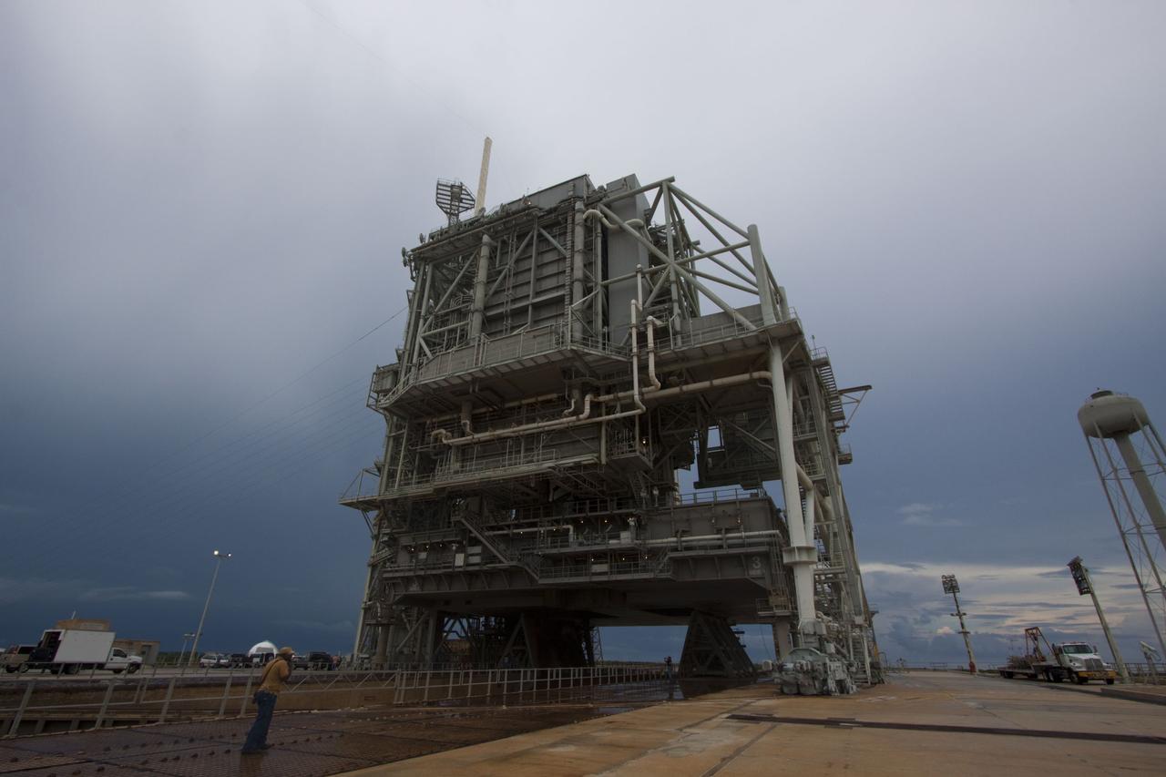 CAPE CANAVERAL, Fla. -- On a cloudy and overcast day on Launch Pad 39A at NASA's Kennedy Space Center in Florida, workers prepare to roll the rotating service structure (RSS) away from space shuttle Atlantis. The RSS provides weather protection and access to the shuttle while it awaits liftoff. RSS "rollback" marks a major milestone in Atlantis' STS-135 mission countdown.          Atlantis and its crew of four; Commander Chris Ferguson, Pilot Doug Hurley and Mission Specialists Sandy Magnus and Rex Walheim, are scheduled to lift off at 11:26 a.m. EDT on July 8 to deliver the Raffaello multi-purpose logistics module packed with supplies and spare parts to the International Space Station. Atlantis also will fly the Robotic Refueling Mission experiment that will investigate the potential for robotically refueling existing satellites in orbit. In addition, Atlantis will return with a failed ammonia pump module to help NASA better understand the failure mechanism and improve pump designs for future systems. STS-135 will be the 33rd flight of Atlantis, the 37th shuttle mission to the space station, and the 135th and final mission of NASA's Space Shuttle Program. For more information visit, www.nasa.gov/mission_pages/shuttle/shuttlemissions/sts135/index.html. Photo credit: NASA/Troy Cryder