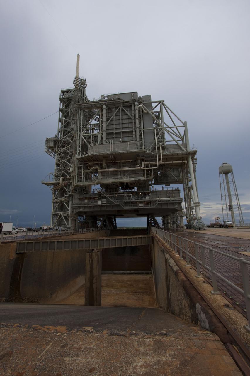 CAPE CANAVERAL, Fla. -- On a cloudy and overcast day on Launch Pad 39A at NASA's Kennedy Space Center in Florida, workers prepare to roll the rotating service structure (RSS) away from space shuttle Atlantis. The RSS provides weather protection and access to the shuttle while it awaits liftoff. RSS "rollback" marks a major milestone in Atlantis' STS-135 mission countdown.          Atlantis and its crew of four; Commander Chris Ferguson, Pilot Doug Hurley and Mission Specialists Sandy Magnus and Rex Walheim, are scheduled to lift off at 11:26 a.m. EDT on July 8 to deliver the Raffaello multi-purpose logistics module packed with supplies and spare parts to the International Space Station. Atlantis also will fly the Robotic Refueling Mission experiment that will investigate the potential for robotically refueling existing satellites in orbit. In addition, Atlantis will return with a failed ammonia pump module to help NASA better understand the failure mechanism and improve pump designs for future systems. STS-135 will be the 33rd flight of Atlantis, the 37th shuttle mission to the space station, and the 135th and final mission of NASA's Space Shuttle Program. For more information visit, www.nasa.gov/mission_pages/shuttle/shuttlemissions/sts135/index.html. Photo credit: NASA/Troy Cryder