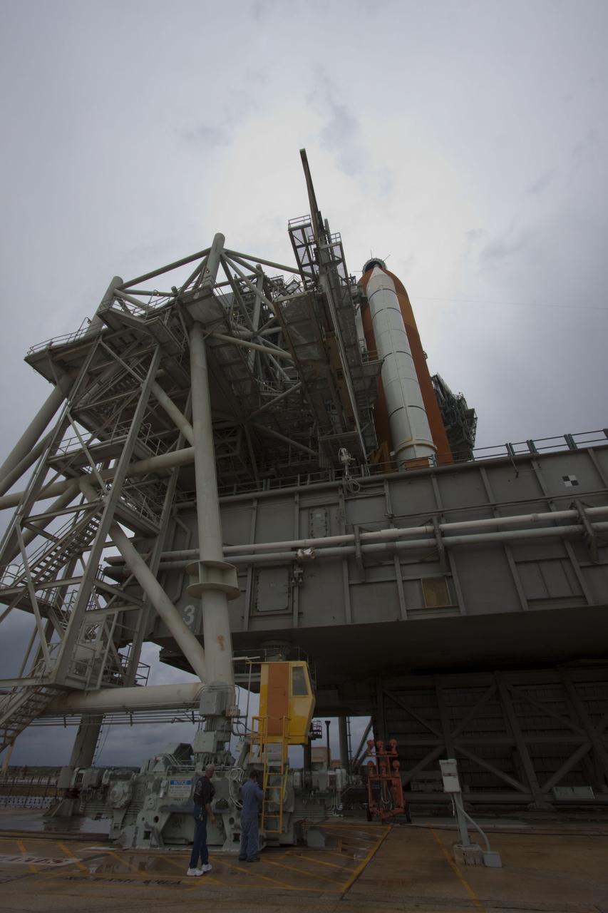 CAPE CANAVERAL, Fla. -- On a cloudy and overcast day on Launch Pad 39A at NASA's Kennedy Space Center in Florida, workers prepare to roll the rotating service structure (RSS) away from space shuttle Atlantis. The RSS provides weather protection and access to the shuttle while it awaits liftoff. RSS "rollback" marks a major milestone in Atlantis' STS-135 mission countdown.          Atlantis and its crew of four; Commander Chris Ferguson, Pilot Doug Hurley and Mission Specialists Sandy Magnus and Rex Walheim, are scheduled to lift off at 11:26 a.m. EDT on July 8 to deliver the Raffaello multi-purpose logistics module packed with supplies and spare parts to the International Space Station. Atlantis also will fly the Robotic Refueling Mission experiment that will investigate the potential for robotically refueling existing satellites in orbit. In addition, Atlantis will return with a failed ammonia pump module to help NASA better understand the failure mechanism and improve pump designs for future systems. STS-135 will be the 33rd flight of Atlantis, the 37th shuttle mission to the space station, and the 135th and final mission of NASA's Space Shuttle Program. For more information visit, www.nasa.gov/mission_pages/shuttle/shuttlemissions/sts135/index.html. Photo credit: NASA/Troy Cryder