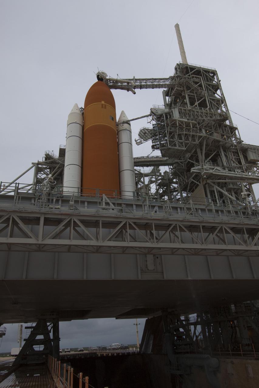CAPE CANAVERAL, Fla. -- On a cloudy and overcast day on Launch Pad 39A at NASA's Kennedy Space Center in Florida, workers prepare to roll the rotating service structure (RSS) away from space shuttle Atlantis. The RSS provides weather protection and access to the shuttle while it awaits liftoff. RSS "rollback" marks a major milestone in Atlantis' STS-135 mission countdown.          Atlantis and its crew of four; Commander Chris Ferguson, Pilot Doug Hurley and Mission Specialists Sandy Magnus and Rex Walheim, are scheduled to lift off at 11:26 a.m. EDT on July 8 to deliver the Raffaello multi-purpose logistics module packed with supplies and spare parts to the International Space Station. Atlantis also will fly the Robotic Refueling Mission experiment that will investigate the potential for robotically refueling existing satellites in orbit. In addition, Atlantis will return with a failed ammonia pump module to help NASA better understand the failure mechanism and improve pump designs for future systems. STS-135 will be the 33rd flight of Atlantis, the 37th shuttle mission to the space station, and the 135th and final mission of NASA's Space Shuttle Program. For more information visit, www.nasa.gov/mission_pages/shuttle/shuttlemissions/sts135/index.html. Photo credit: NASA/Troy Cryder