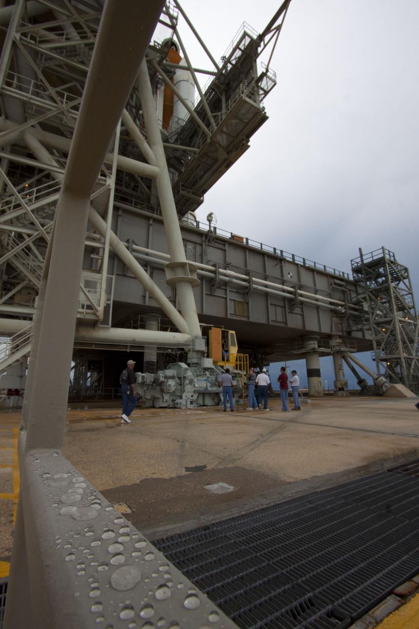 CAPE CANAVERAL, Fla. -- On a cloudy and overcast day on Launch Pad 39A at NASA's Kennedy Space Center in Florida, workers prepare to roll the rotating service structure (RSS) away from space shuttle Atlantis. The RSS provides weather protection and access to the shuttle while it awaits liftoff. RSS "rollback" marks a major milestone in Atlantis' STS-135 mission countdown.          Atlantis and its crew of four; Commander Chris Ferguson, Pilot Doug Hurley and Mission Specialists Sandy Magnus and Rex Walheim, are scheduled to lift off at 11:26 a.m. EDT on July 8 to deliver the Raffaello multi-purpose logistics module packed with supplies and spare parts to the International Space Station. Atlantis also will fly the Robotic Refueling Mission experiment that will investigate the potential for robotically refueling existing satellites in orbit. In addition, Atlantis will return with a failed ammonia pump module to help NASA better understand the failure mechanism and improve pump designs for future systems. STS-135 will be the 33rd flight of Atlantis, the 37th shuttle mission to the space station, and the 135th and final mission of NASA's Space Shuttle Program. For more information visit, www.nasa.gov/mission_pages/shuttle/shuttlemissions/sts135/index.html. Photo credit: NASA/Troy Cryder