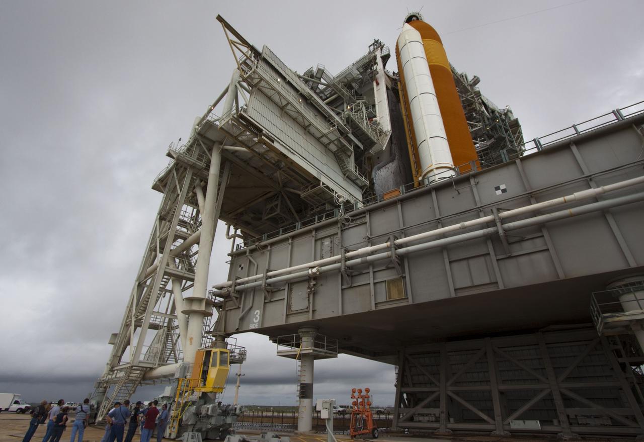 CAPE CANAVERAL, Fla. -- On a cloudy and overcast day on Launch Pad 39A at NASA's Kennedy Space Center in Florida, the rotating service structure (RSS) begins to roll away from space shuttle Atlantis. The RSS provides weather protection and access to the shuttle while it awaits liftoff. RSS "rollback" marks a major milestone in Atlantis' STS-135 mission countdown.        Atlantis and its crew of four; Commander Chris Ferguson, Pilot Doug Hurley and Mission Specialists Sandy Magnus and Rex Walheim, are scheduled to lift off at 11:26 a.m. EDT on July 8 to deliver the Raffaello multi-purpose logistics module packed with supplies and spare parts to the International Space Station. Atlantis also will fly the Robotic Refueling Mission experiment that will investigate the potential for robotically refueling existing satellites in orbit. In addition, Atlantis will return with a failed ammonia pump module to help NASA better understand the failure mechanism and improve pump designs for future systems. STS-135 will be the 33rd flight of Atlantis, the 37th shuttle mission to the space station, and the 135th and final mission of NASA's Space Shuttle Program. For more information visit, www.nasa.gov/mission_pages/shuttle/shuttlemissions/sts135/index.html. Photo credit: NASA/Troy Cryder