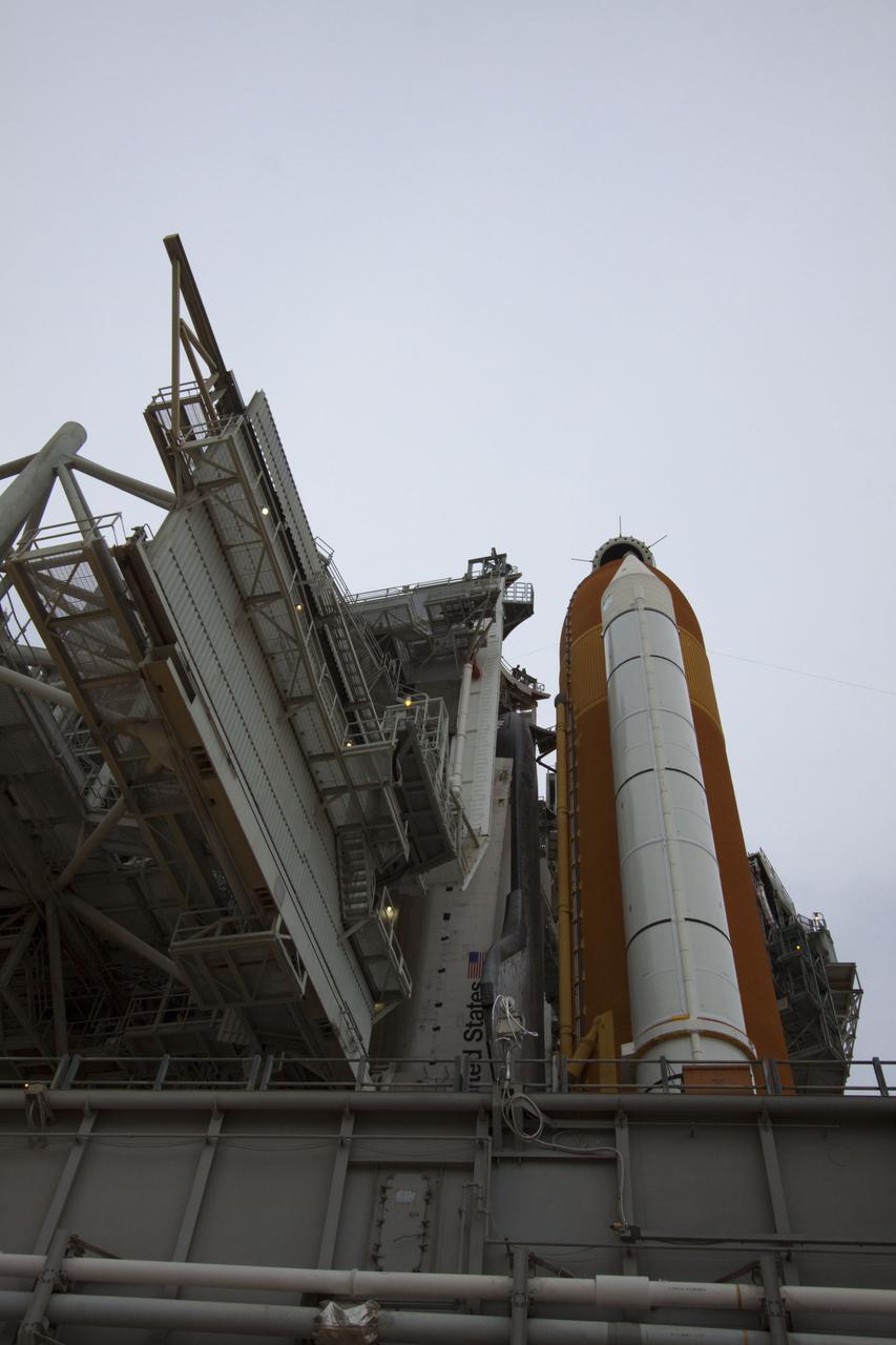 CAPE CANAVERAL, Fla. -- On a cloudy and overcast day on Launch Pad 39A at NASA's Kennedy Space Center in Florida, the rotating service structure (RSS) begins to roll away from space shuttle Atlantis. The RSS provides weather protection and access to the shuttle while it awaits liftoff. RSS "rollback" marks a major milestone in Atlantis' STS-135 mission countdown.        Atlantis and its crew of four; Commander Chris Ferguson, Pilot Doug Hurley and Mission Specialists Sandy Magnus and Rex Walheim, are scheduled to lift off at 11:26 a.m. EDT on July 8 to deliver the Raffaello multi-purpose logistics module packed with supplies and spare parts to the International Space Station. Atlantis also will fly the Robotic Refueling Mission experiment that will investigate the potential for robotically refueling existing satellites in orbit. In addition, Atlantis will return with a failed ammonia pump module to help NASA better understand the failure mechanism and improve pump designs for future systems. STS-135 will be the 33rd flight of Atlantis, the 37th shuttle mission to the space station, and the 135th and final mission of NASA's Space Shuttle Program. For more information visit, www.nasa.gov/mission_pages/shuttle/shuttlemissions/sts135/index.html. Photo credit: NASA/Troy Cryder