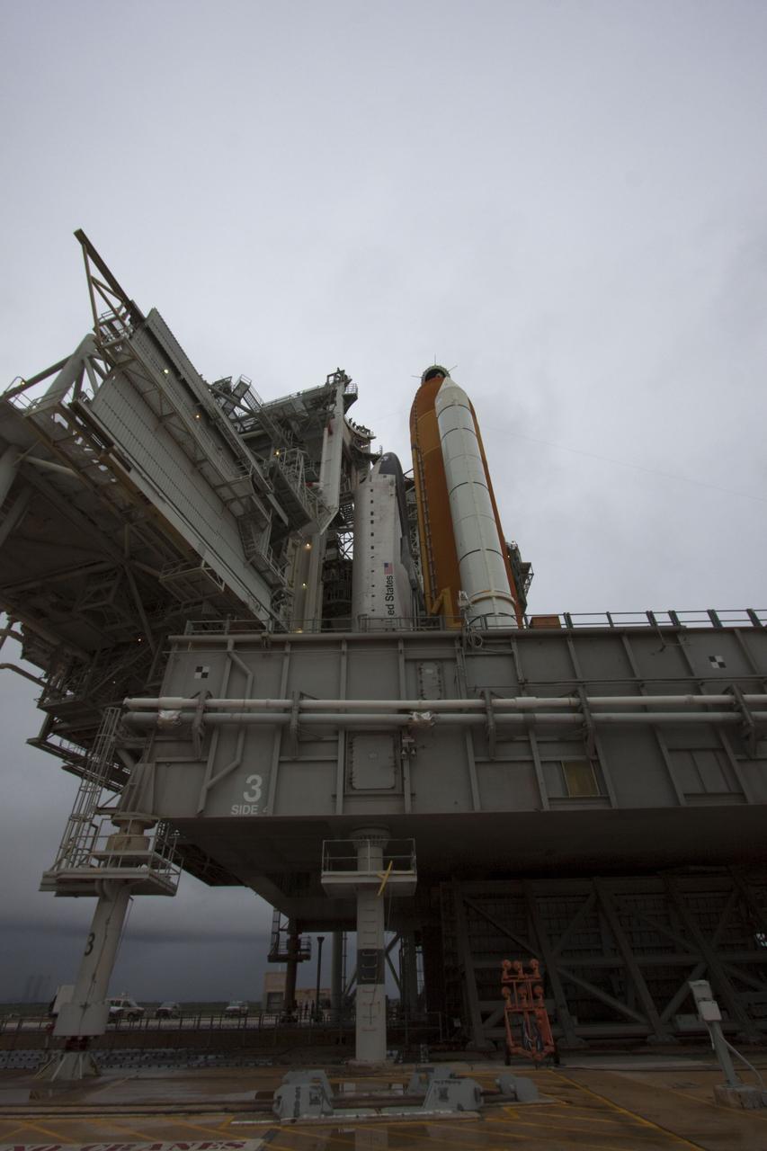CAPE CANAVERAL, Fla. -- On a cloudy and overcast day on Launch Pad 39A at NASA's Kennedy Space Center in Florida, the rotating service structure (RSS) slowly rolls away from space shuttle Atlantis. The RSS provides weather protection and access to the shuttle while it awaits liftoff. RSS "rollback" marks a major milestone in Atlantis' STS-135 mission countdown.    Atlantis and its crew of four; Commander Chris Ferguson, Pilot Doug Hurley and Mission Specialists Sandy Magnus and Rex Walheim, are scheduled to lift off at 11:26 a.m. EDT on July 8 to deliver the Raffaello multi-purpose logistics module packed with supplies and spare parts to the International Space Station. Atlantis also will fly the Robotic Refueling Mission experiment that will investigate the potential for robotically refueling existing satellites in orbit. In addition, Atlantis will return with a failed ammonia pump module to help NASA better understand the failure mechanism and improve pump designs for future systems. STS-135 will be the 33rd flight of Atlantis, the 37th shuttle mission to the space station, and the 135th and final mission of NASA's Space Shuttle Program. For more information visit, www.nasa.gov/mission_pages/shuttle/shuttlemissions/sts135/index.html. Photo credit: NASA/Troy Cryder
