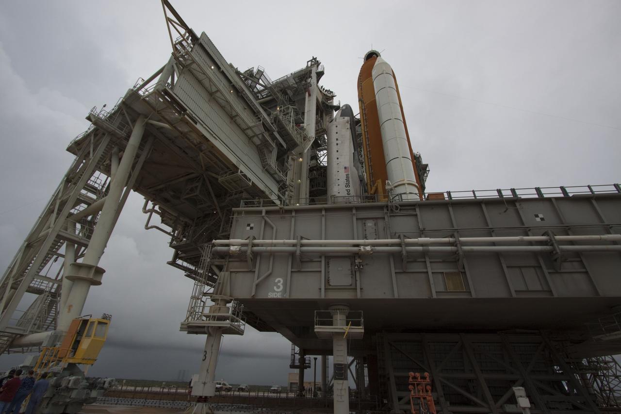 CAPE CANAVERAL, Fla. -- On a cloudy and overcast day on Launch Pad 39A at NASA's Kennedy Space Center in Florida, the rotating service structure (RSS) slowly rolls away from space shuttle Atlantis. The RSS provides weather protection and access to the shuttle while it awaits liftoff. RSS "rollback" marks a major milestone in Atlantis' STS-135 mission countdown.    Atlantis and its crew of four; Commander Chris Ferguson, Pilot Doug Hurley and Mission Specialists Sandy Magnus and Rex Walheim, are scheduled to lift off at 11:26 a.m. EDT on July 8 to deliver the Raffaello multi-purpose logistics module packed with supplies and spare parts to the International Space Station. Atlantis also will fly the Robotic Refueling Mission experiment that will investigate the potential for robotically refueling existing satellites in orbit. In addition, Atlantis will return with a failed ammonia pump module to help NASA better understand the failure mechanism and improve pump designs for future systems. STS-135 will be the 33rd flight of Atlantis, the 37th shuttle mission to the space station, and the 135th and final mission of NASA's Space Shuttle Program. For more information visit, www.nasa.gov/mission_pages/shuttle/shuttlemissions/sts135/index.html. Photo credit: NASA/Troy Cryder