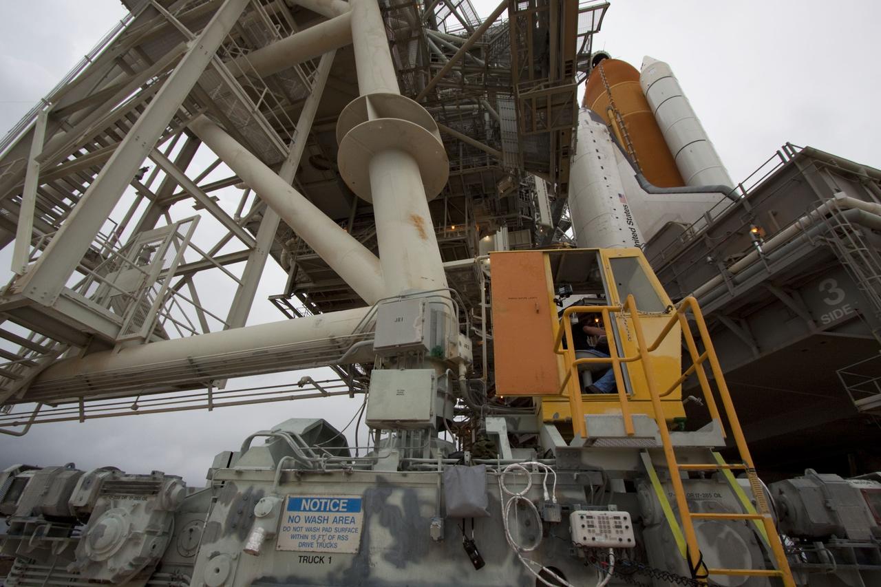 CAPE CANAVERAL, Fla. -- A worker in the control booth on Launch Pad 39A at NASA's Kennedy Space Center in Florida monitors the progress of the rotating service structure (RSS) as it is rolled back revealing space shuttle Atlantis. The structure provides weather protection and access to the shuttle while it awaits liftoff on the pad. RSS "rollback" marks a major milestone in Atlantis' STS-135 mission countdown.          Atlantis and its crew of four; Commander Chris Ferguson, Pilot Doug Hurley and Mission Specialists Sandy Magnus and Rex Walheim, are scheduled to lift off at 11:26 a.m. EDT on July 8 to deliver the Raffaello multi-purpose logistics module packed with supplies and spare parts to the International Space Station. Atlantis also will fly the Robotic Refueling Mission experiment that will investigate the potential for robotically refueling existing satellites in orbit. In addition, Atlantis will return with a failed ammonia pump module to help NASA better understand the failure mechanism and improve pump designs for future systems. STS-135 will be the 33rd flight of Atlantis, the 37th shuttle mission to the space station, and the 135th and final mission of NASA's Space Shuttle Program. For more information visit, www.nasa.gov/mission_pages/shuttle/shuttlemissions/sts135/index.html. Photo credit: NASA/Troy Cryder