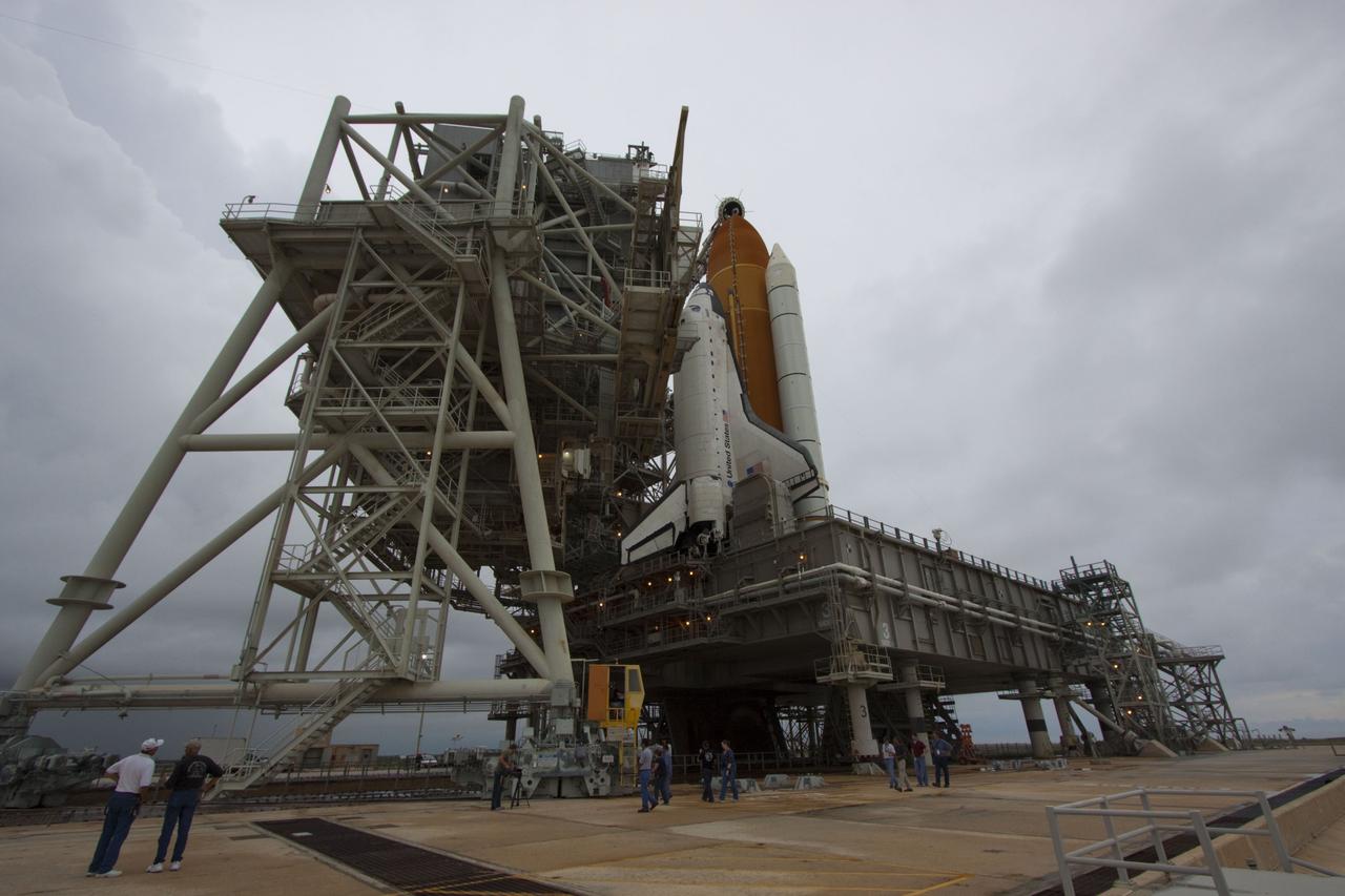 CAPE CANAVERAL, Fla. -- On a cloudy and overcast day on Launch Pad 39A at NASA's Kennedy Space Center in Florida, workers monitor the progress of the rotating service structure (RSS) as it rolls away from space shuttle Atlantis. The RSS provides weather protection and access to the shuttle while it awaits liftoff. RSS "rollback" marks a major milestone in Atlantis' STS-135 mission countdown.      Atlantis and its crew of four; Commander Chris Ferguson, Pilot Doug Hurley and Mission Specialists Sandy Magnus and Rex Walheim, are scheduled to lift off at 11:26 a.m. EDT on July 8 to deliver the Raffaello multi-purpose logistics module packed with supplies and spare parts to the International Space Station. Atlantis also will fly the Robotic Refueling Mission experiment that will investigate the potential for robotically refueling existing satellites in orbit. In addition, Atlantis will return with a failed ammonia pump module to help NASA better understand the failure mechanism and improve pump designs for future systems. STS-135 will be the 33rd flight of Atlantis, the 37th shuttle mission to the space station, and the 135th and final mission of NASA's Space Shuttle Program. For more information visit, www.nasa.gov/mission_pages/shuttle/shuttlemissions/sts135/index.html. Photo credit: NASA/Troy Cryder