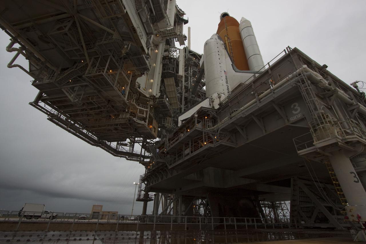 CAPE CANAVERAL, Fla. -- On a cloudy and overcast day on Launch Pad 39A at NASA's Kennedy Space Center in Florida, the rotating service structure (RSS) slowly rolls away revealing space shuttle Atlantis. The RSS provides weather protection and access to the shuttle while it awaits liftoff. RSS "rollback" marks a major milestone in Atlantis' STS-135 mission countdown.    Atlantis and its crew of four; Commander Chris Ferguson, Pilot Doug Hurley and Mission Specialists Sandy Magnus and Rex Walheim, are scheduled to lift off at 11:26 a.m. EDT on July 8 to deliver the Raffaello multi-purpose logistics module packed with supplies and spare parts to the International Space Station. Atlantis also will fly the Robotic Refueling Mission experiment that will investigate the potential for robotically refueling existing satellites in orbit. In addition, Atlantis will return with a failed ammonia pump module to help NASA better understand the failure mechanism and improve pump designs for future systems. STS-135 will be the 33rd flight of Atlantis, the 37th shuttle mission to the space station, and the 135th and final mission of NASA's Space Shuttle Program. For more information visit, www.nasa.gov/mission_pages/shuttle/shuttlemissions/sts135/index.html. Photo credit: NASA/Troy Cryder