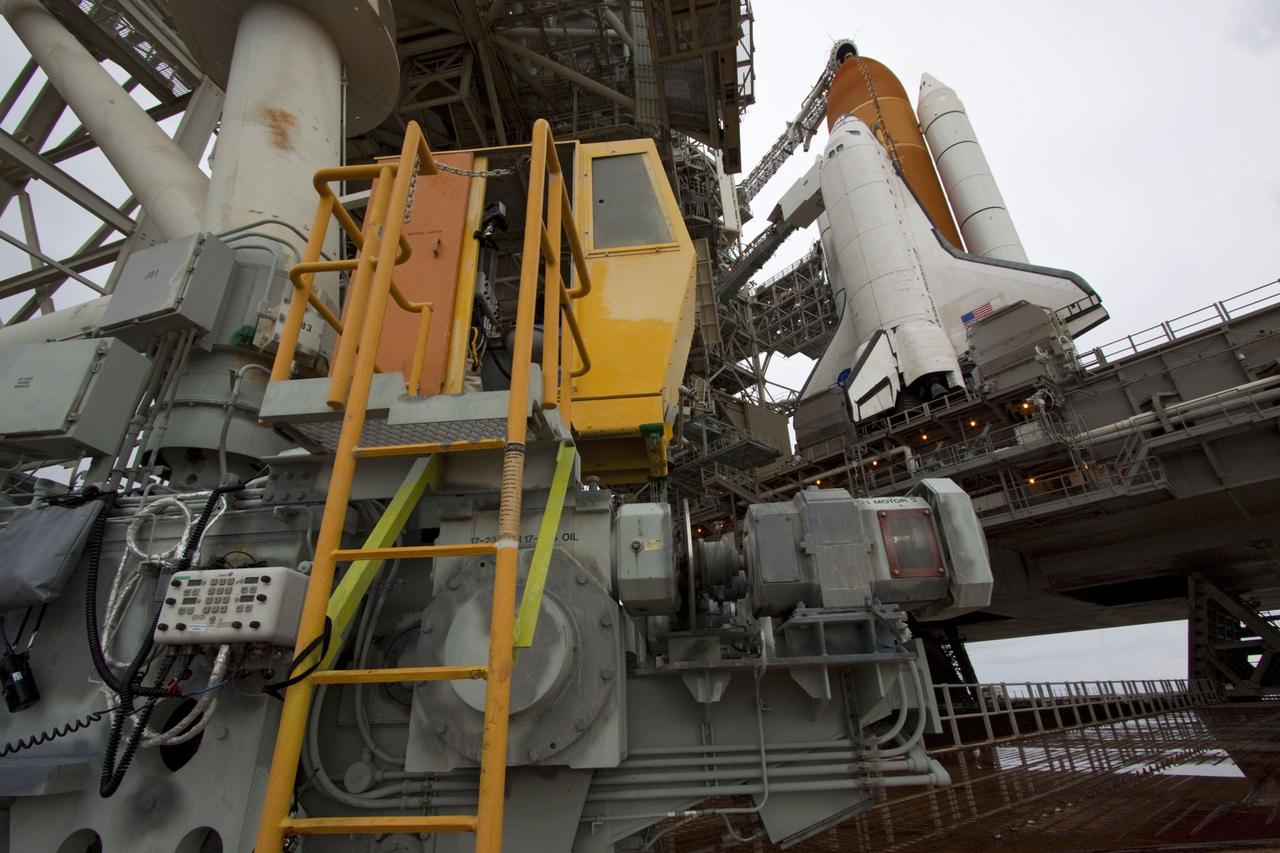 CAPE CANAVERAL, Fla. -- A worker in the control booth on Launch Pad 39A at NASA's Kennedy Space Center in Florida monitors the progress of the rotating service structure (RSS) as it is rolled back revealing space shuttle Atlantis. The structure provides weather protection and access to the shuttle while it awaits liftoff on the pad. RSS "rollback" marks a major milestone in Atlantis' STS-135 mission countdown.          Atlantis and its crew of four; Commander Chris Ferguson, Pilot Doug Hurley and Mission Specialists Sandy Magnus and Rex Walheim, are scheduled to lift off at 11:26 a.m. EDT on July 8 to deliver the Raffaello multi-purpose logistics module packed with supplies and spare parts to the International Space Station. Atlantis also will fly the Robotic Refueling Mission experiment that will investigate the potential for robotically refueling existing satellites in orbit. In addition, Atlantis will return with a failed ammonia pump module to help NASA better understand the failure mechanism and improve pump designs for future systems. STS-135 will be the 33rd flight of Atlantis, the 37th shuttle mission to the space station, and the 135th and final mission of NASA's Space Shuttle Program. For more information visit, www.nasa.gov/mission_pages/shuttle/shuttlemissions/sts135/index.html. Photo credit: NASA/Troy Cryder