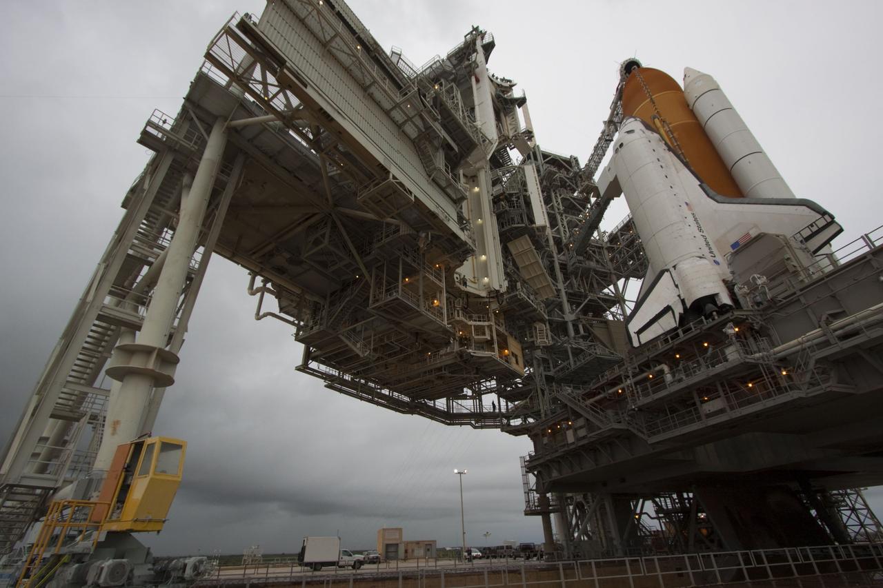 CAPE CANAVERAL, Fla. -- On a cloudy and overcast day on Launch Pad 39A at NASA's Kennedy Space Center in Florida, the rotating service structure (RSS) slowly rolls away revealing space shuttle Atlantis. The RSS provides weather protection and access to the shuttle while it awaits liftoff. RSS "rollback" marks a major milestone in Atlantis' STS-135 mission countdown.        Atlantis and its crew of four; Commander Chris Ferguson, Pilot Doug Hurley and Mission Specialists Sandy Magnus and Rex Walheim, are scheduled to lift off at 11:26 a.m. EDT on July 8 to deliver the Raffaello multi-purpose logistics module packed with supplies and spare parts to the International Space Station. Atlantis also will fly the Robotic Refueling Mission experiment that will investigate the potential for robotically refueling existing satellites in orbit. In addition, Atlantis will return with a failed ammonia pump module to help NASA better understand the failure mechanism and improve pump designs for future systems. STS-135 will be the 33rd flight of Atlantis, the 37th shuttle mission to the space station, and the 135th and final mission of NASA's Space Shuttle Program. For more information visit, www.nasa.gov/mission_pages/shuttle/shuttlemissions/sts135/index.html. Photo credit: NASA/Troy Cryder